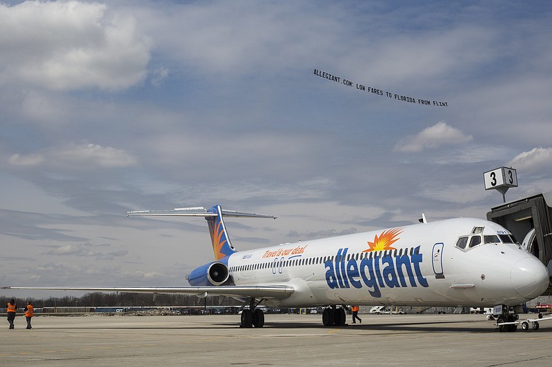 
              FILE - In this Wednesday, April 13, 2016 file photo, a small plane with a banner flies over Flint Bishop Airport to celebrate the ribbon cutting for Allegiant Air joining Flint Bishop International Airport in Flint, Mich. Discount airline Allegiant Air is set to land at Newark Liberty International Airport. Allegiant has been given final approval to begin offering service at the airport in November. Tickets can be purchased beginning Tuesday, June 28, some for as low as $39 one-way. (Conor Ralph/The Flint Journal- MLive.com via AP, File) MANDATORY CREDIT
            