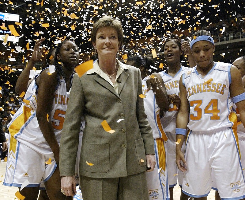 In this Jan. 14, 2003, file photo, Tennessee head coach Pat Summitt, center, smiles as she stands with her team after defeating DePaul, 76-57, to get her 800th career win, in Knoxville. Tye'sha Fluke is at left, Courtney McDaniel (34), right, and Ashley Robinson, second from right. Summitt, the winningest coach in Division I college basketball history who uplifted the women's game from obscurity to national prominence during her career at Tennessee, died Tuesday morning, June 28, 2016. She was 64.