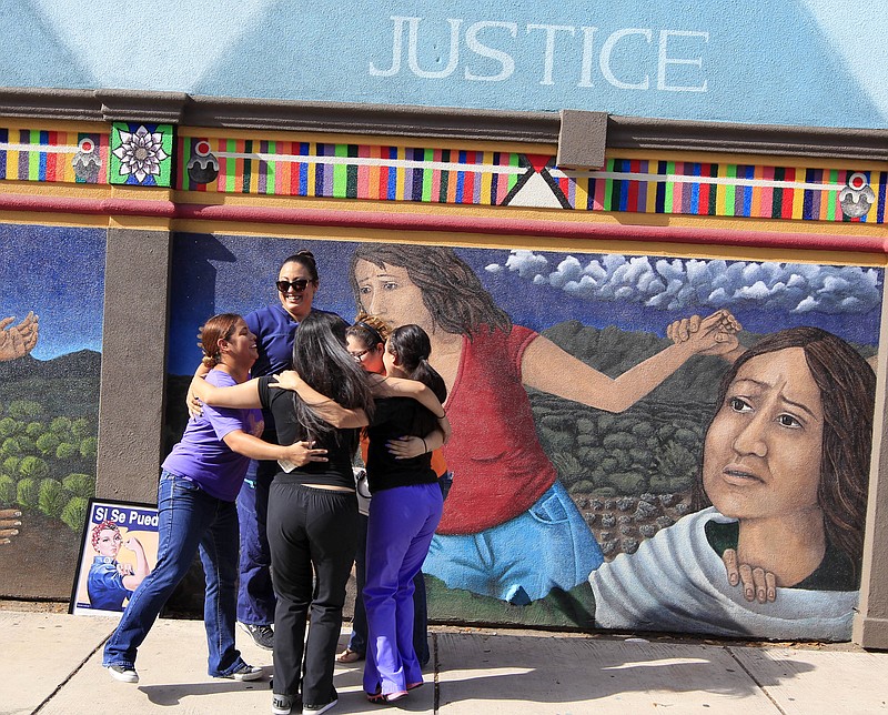 Staff members of Whole Woman's Health celebrate in front of a mural on the side of the building after the U.S. Supreme Court ruling against Texas' abortion restrictions Monday June 27, 2016, in McAllen, Texas. Whole Woman's Health is a abortion provider that stayed open despite the restrictions as many other providers closed over the past two years.