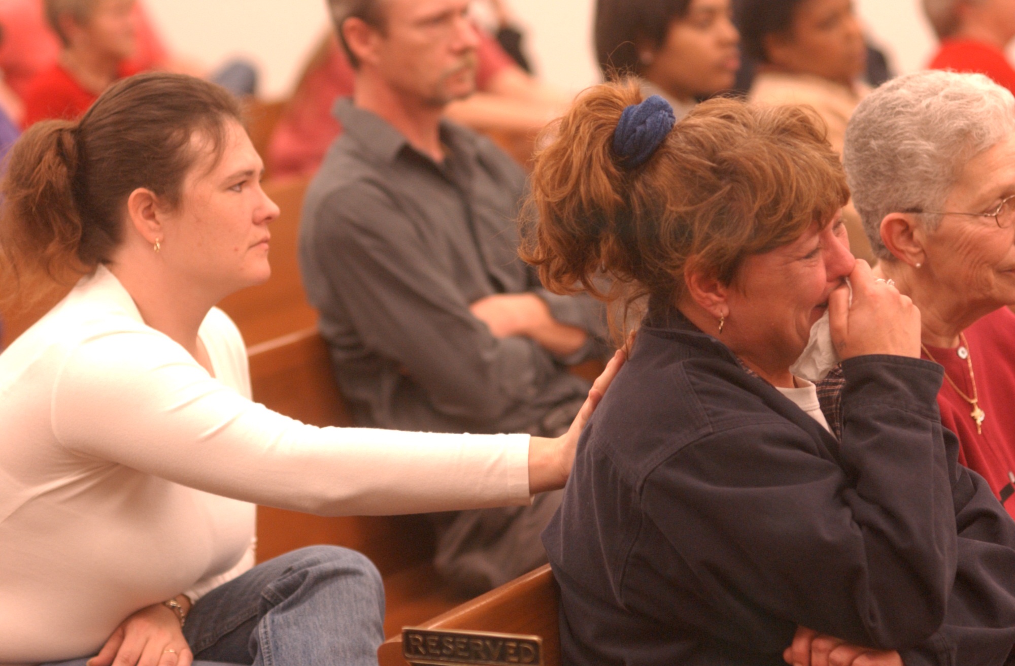 Grieving family members Stacy Harris, left, leans forward to console Vivica Roe as she remembers her dad, Robert Clay Roe, Sr. as 10 witnesses took the stand at the Bradley County, Tenn. Justice Complex to tell Brent Marsh, and the court, of their hardships since the beginning of the Tri-State Crematory Case. Ms. Roe