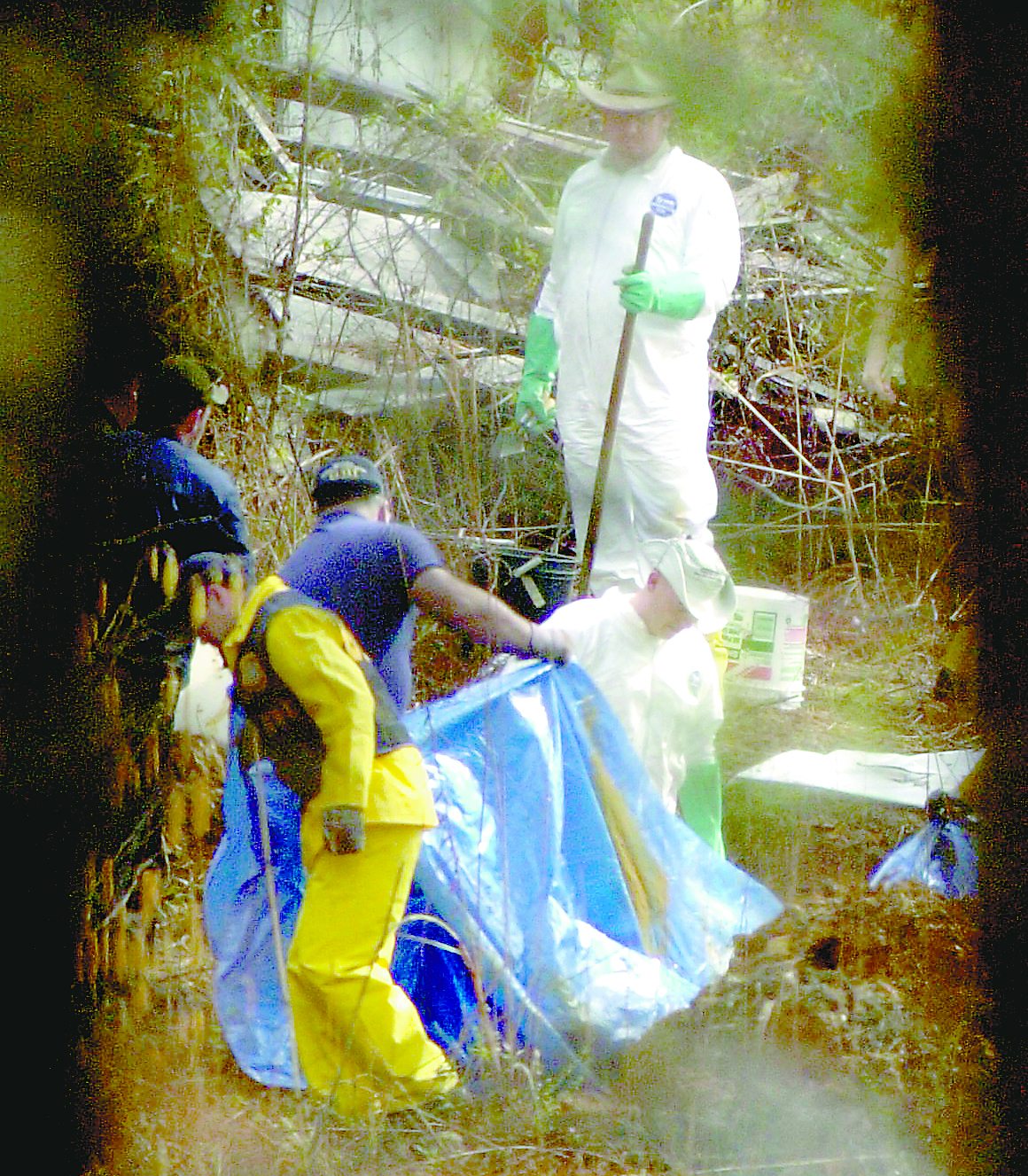 GBI workers collect human remains from the property of Brent Marsh who lives near the Tri State Crematory Wednesday Feb. 20, 2002 in Noble, Ga.