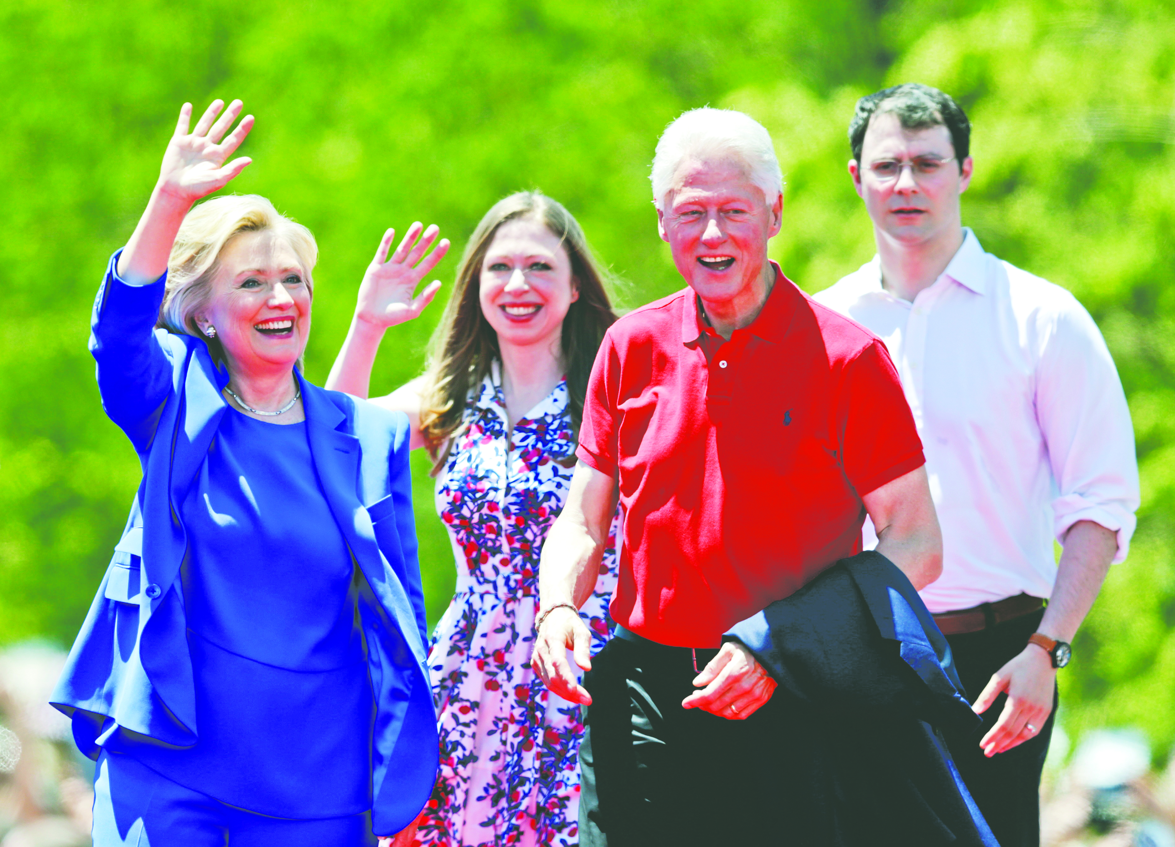 Democratic presidential candidate former Secretary of State Hillary Rodham Clinton waves to supporters as her husband former President Bill Clinton, second from right, Chelsea Clinton, second from left, and her husband Marc Mezvinsky, join on stage Saturday, June 13, 2015, on Roosevelt Island in New York.  (AP Photo/Frank Franklin II)