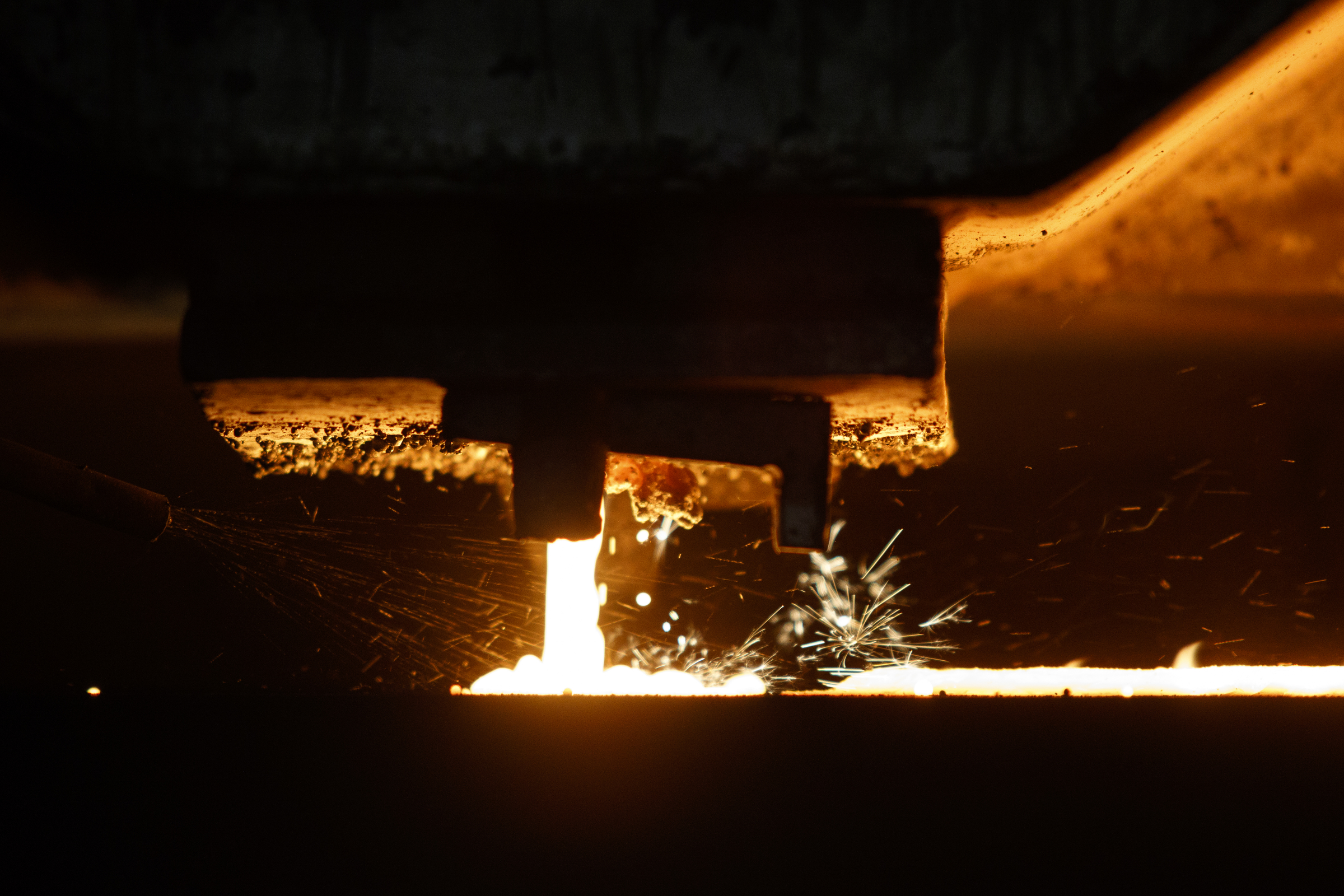 A molding machine pours molten metal into sand casts at Lodge Manufacturing on Wednesday, June 29, 2016, in South Pittsburg, Tenn. The cast iron cookware manufacturer broke ground Wednesday on a new foundry.