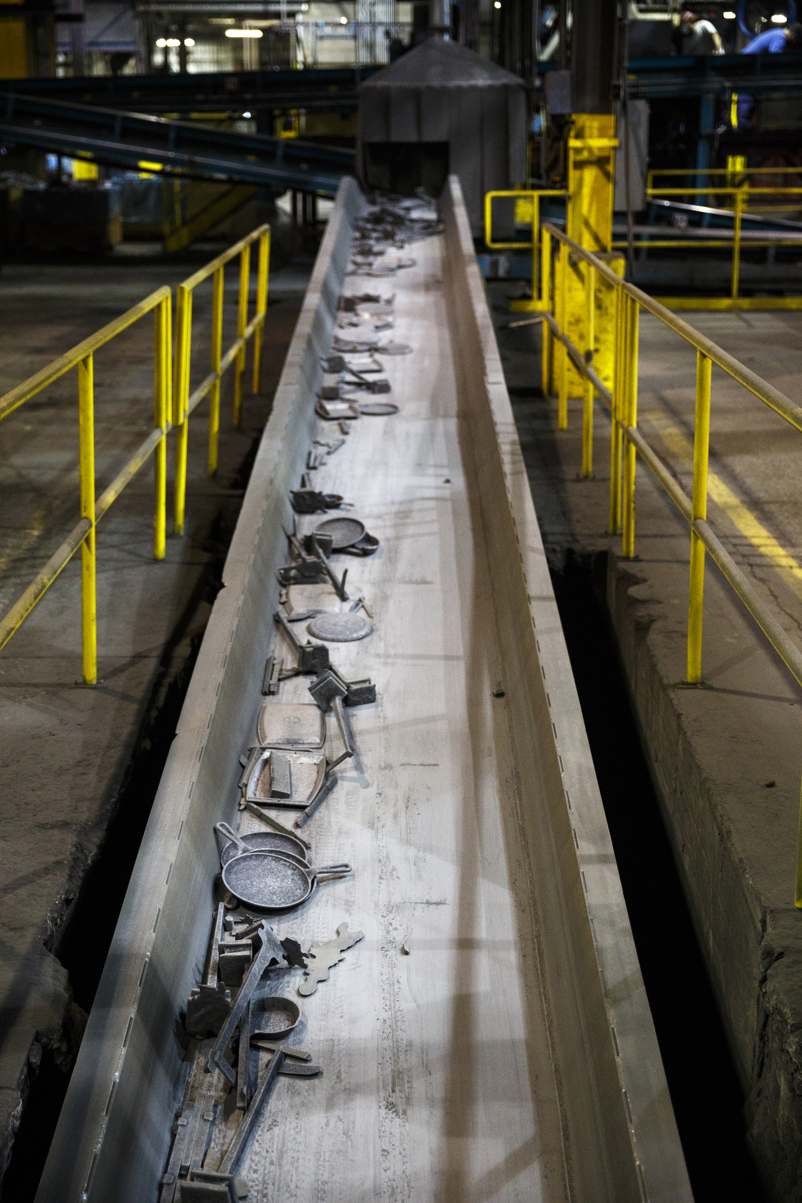Molded cast iron cookware is moved with leftover metal on a conveyor belt at Lodge Manufacturing on Wednesday, June 29, 2016, in South Pittsburg, Tenn. The cast iron cookware manufacturer broke ground Wednesday on a new foundry.