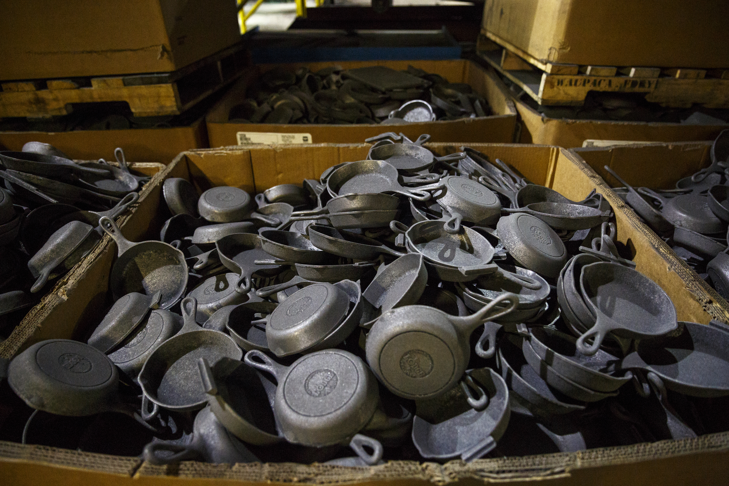 Molded cast iron cookware is collected in boxes before being seasoned at Lodge Manufacturing on Wednesday, June 29, 2016, in South Pittsburg, Tenn. The cast iron cookware manufacturer broke ground Wednesday on a new foundry.