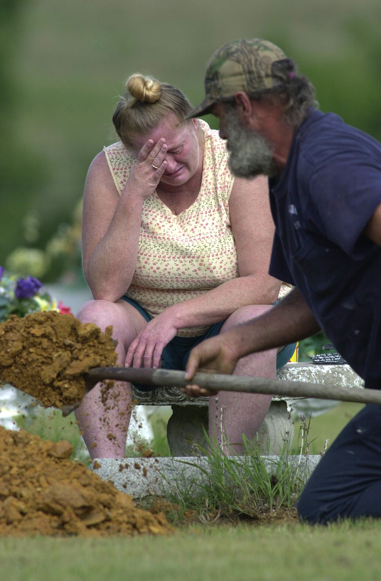 Staff Photo by Stephen Jones- Saturday morning Jackie Degraw and her brother Herbert Duncan unearth an urn they thought had contained the cremains of their mother from a cemetary in Noble, Georgia.  DNA tests recently confirmed that skeletal remains found on the property of the Marsh Crematory are those of her mother. The urn and its contents will be turned over to the Walker County Coroner's office.