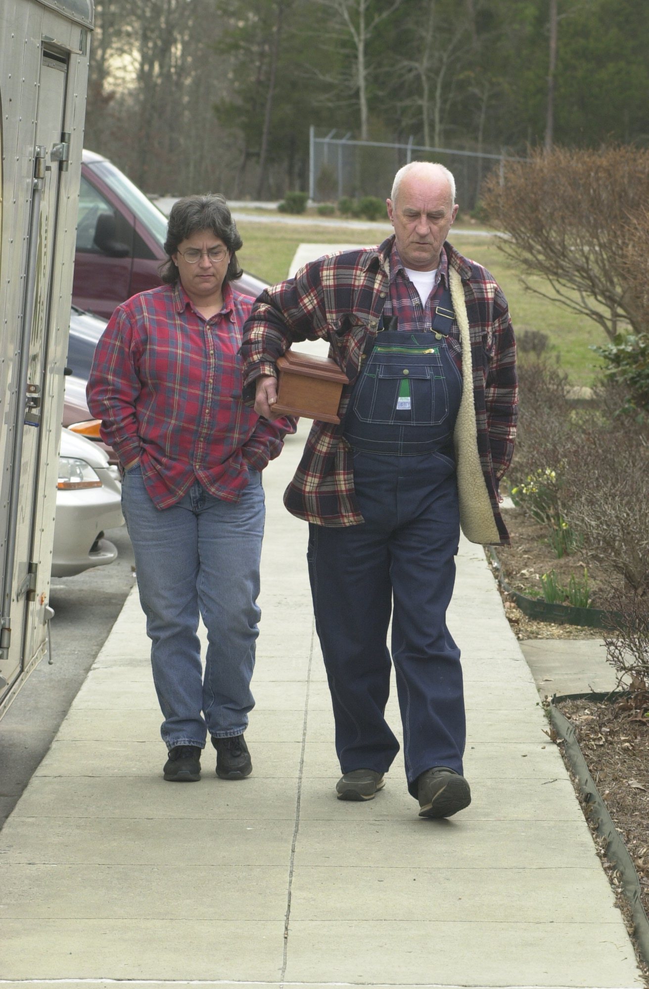 File Photo by John Rawlston        James Nicely, right, accompanied by his daughter, Tina Nicely Boyd, from Middle Valley, TN, carries a box that they thought contained the remains of his mother into the Walker County Civic Center Tuesday, February 19, 2002. 