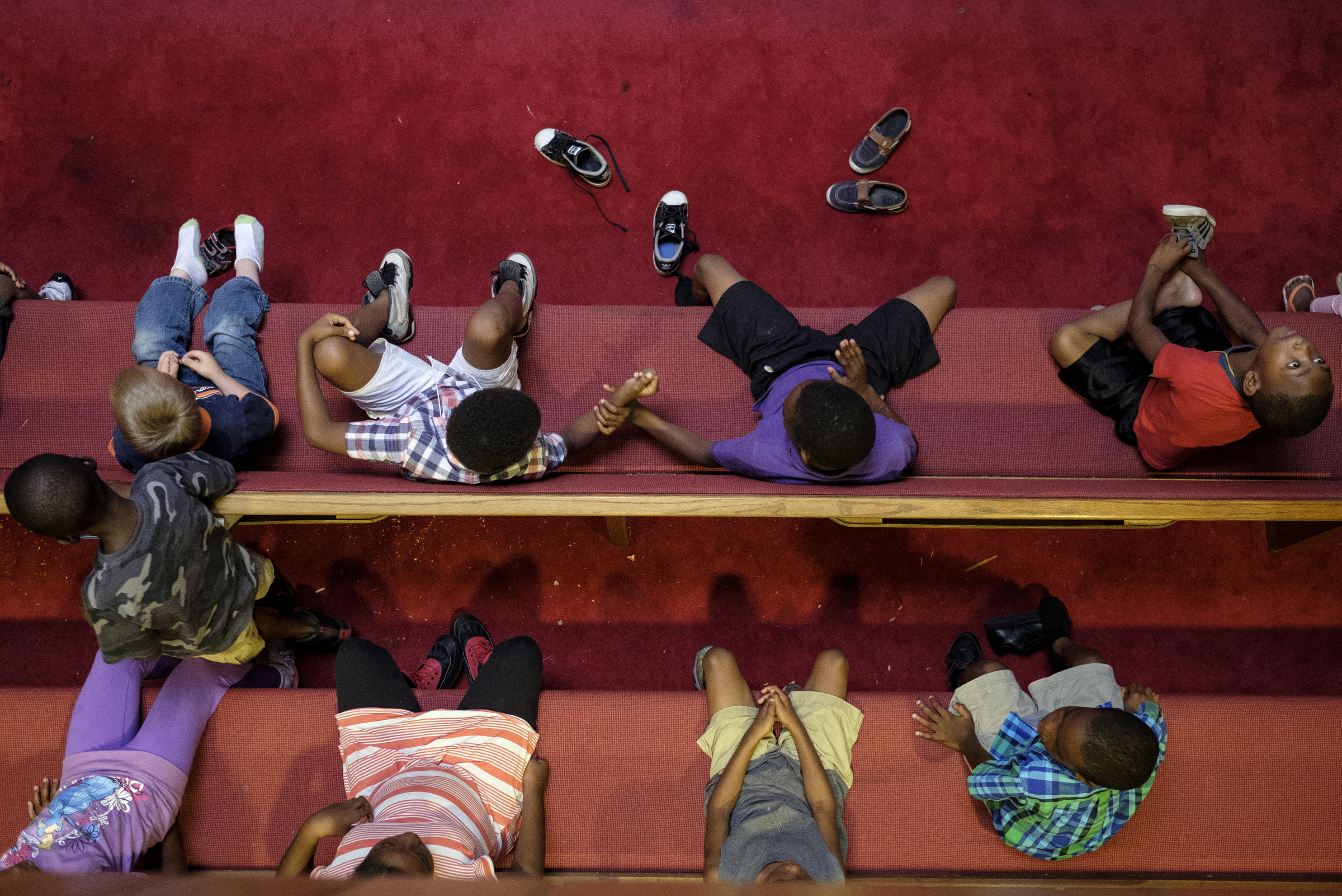 Kids sit in church pews as a video lesson plays on a screen at a camp for kids operated by Gloria Griffith at Renaissance Presbyterian Church on Tuesday, June 28, 2016, in Chattanooga, Tenn. Griffith has operated the camp for 5 years, but because of health problems, Griffith expects that she will have to end the camp this month if she can't find someone to take her place.