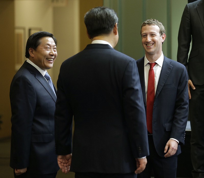 
              FILE - In this Wednesday, Sept. 23, 2015, file photo, Chinese President Xi Jinping, center, talks with Facebook Chief Executive Mark Zuckerberg, right, as Lu Wei, left, China's Internet czar, looks on during a gathering of CEOs and other executives at Microsoft's main campus in Redmond, Wash. China is replacing its top internet regulator and censor, Lu Wei, who had become the face of the government's increasingly complicated dealings with foreign technology companies. (AP Photo/Ted S. Warren, Pool, File)
            