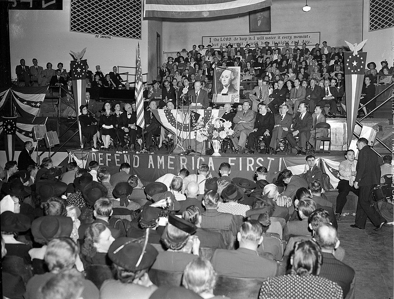 
              File-This Oct. 3, 1941, file photo shows a crowd of over 4,000 people filled the Gospel Tabernacle in Fort Wayne, Ind., to hear Col. Charles Lindbergh, seen on the speaker's stand in the center, address a rally of the America First Committee. Presumptive Republican presidential nominee Donald Trump boils down his foreign policy agenda to two words: “America First.”
For students of U.S. history, that slogan harkens back to the tumultuous presidential election of 1940, when hundreds of thousands of Americans joined the anti-war America First Committee. That isolationist group’s primary goal was to keep the United States from joining Britain in the fight against Nazi Germany, which by then had overrun nearly all of Europe. But the committee is also remembered for the unvarnished anti-Semitism of some of its most prominent members and praise for the economic policies of Adolf Hitler. (AP Photo/File)
            