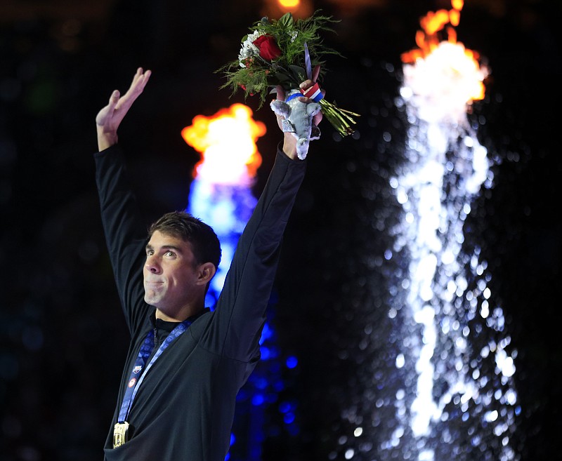 
              Michael Phelps waves after receiving his gold medal in the men's 200-meter butterfly at the U.S. Olympic swimming trials in Omaha, Neb., Wednesday, June 29, 2016. (AP Photo/Orlin Wagner)
            