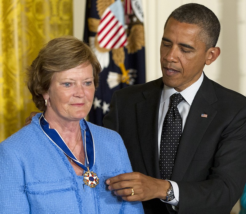 FILE- In this May 29, 2012, file photo, President Barack Obama awards Pat Summitt, former Tennessee basketball head coach, the Presidential Medal of Freedom in the East Room of the White House in Washington. Summitt, the winningest coach in Division I college basketball history who uplifted the women's game from obscurity to national prominence during her career at Tennessee, died Tuesday morning, June 28, 2016. She was 64. AP Photo/Carolyn Kaster, File