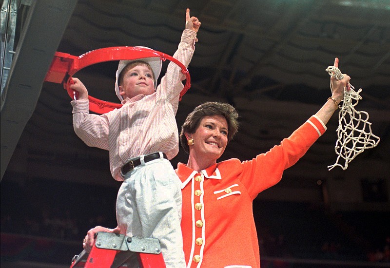 In this March 31, 1996, file photo, Tennessee coach Pat Summitt and son Tyler, take down the net after Tennessee defeated Georgia 83-65 in the title game at the NCAA women's basketball Final Four at Charlotte Coliseum in Charlotte, N.C. Summitt, the winningest coach in Division I college basketball history who uplifted the women's game from obscurity to national prominence during her career at Tennessee, died Tuesday morning, June 28, 2016. She was 64. 