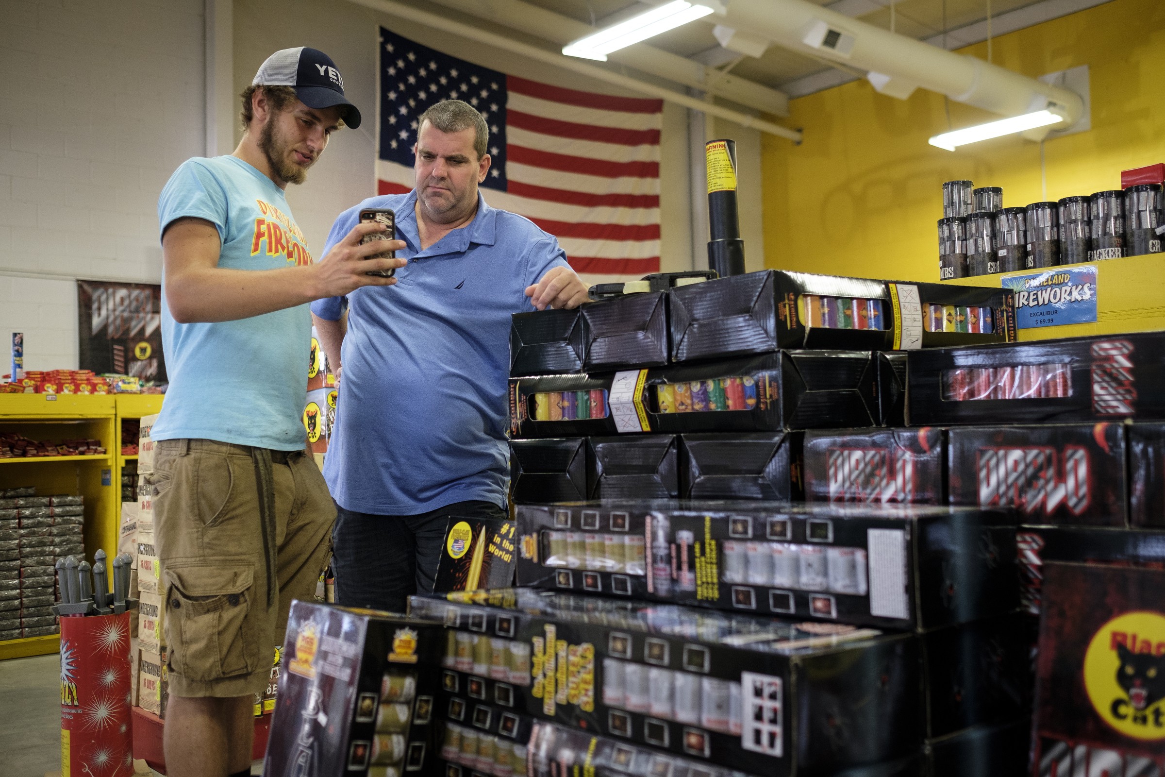 Rhett Anderson, left, shows Layton Hampton a video of a firework called Excalibur, one of the store's most popular sellers, as Hampton shops in preparation for the 4th of July at Dixieland Fireworks on Wednesday, June 29, 2016, in East Ridge, Tenn. The days preceding the holiday are the store's busiest.