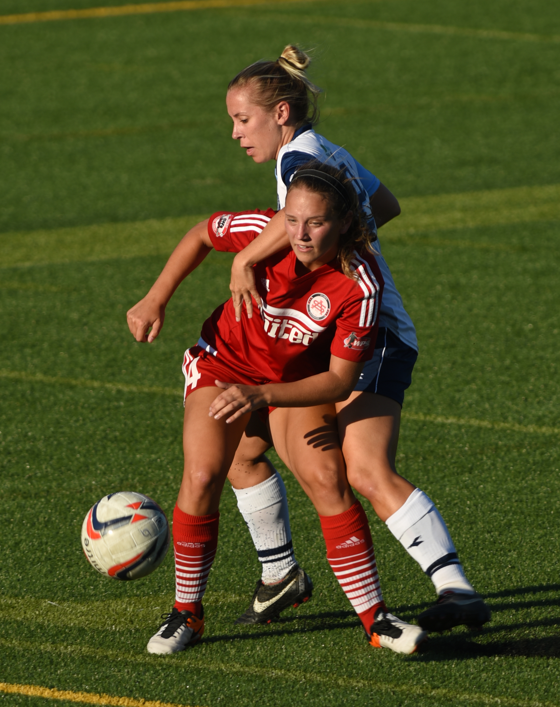 Chattanooga Football Club's Kelly Downs ends up with a yellow card after tangling with Atlanta's Heather Ferrari Thursday, June 30, 2016 at Finley Stadium.