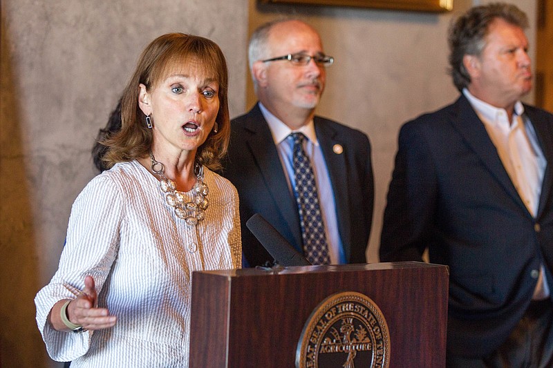 
              House Speaker Beth Harwell, R-Nashville, speaks during a news conference at the state Capitol in Nashville, Tenn., on Thursday, June 30, 2016, about a health coverage task force's proposals for Medicaid expansion in Tennessee. From right behind her are Republican Reps. Steve McManus of Memphis and Roger Kane of Knoxville. (AP Photo/Erik Schelzig)
            