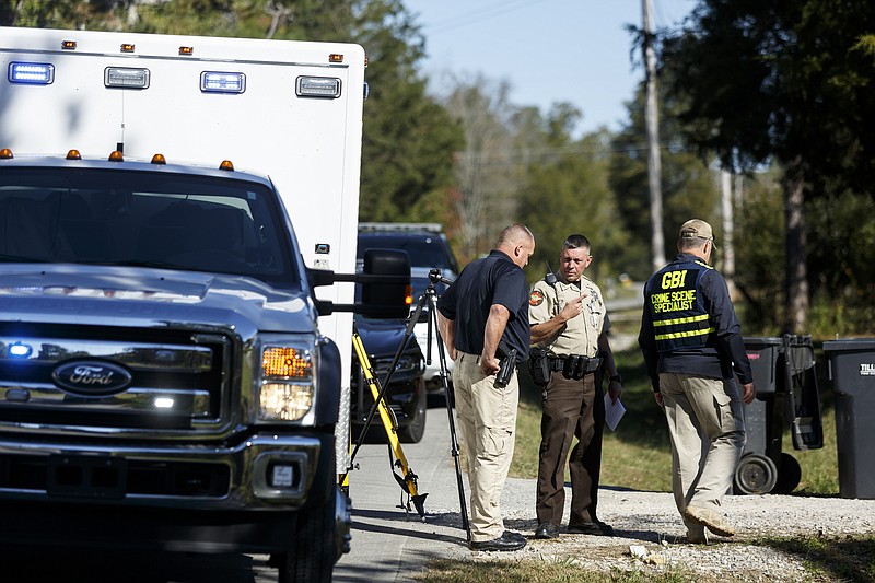 Investigators work the scene of a shooting that took place Oct. 19, 2015, on Straight Gut Road in Rock Spring, Ga.