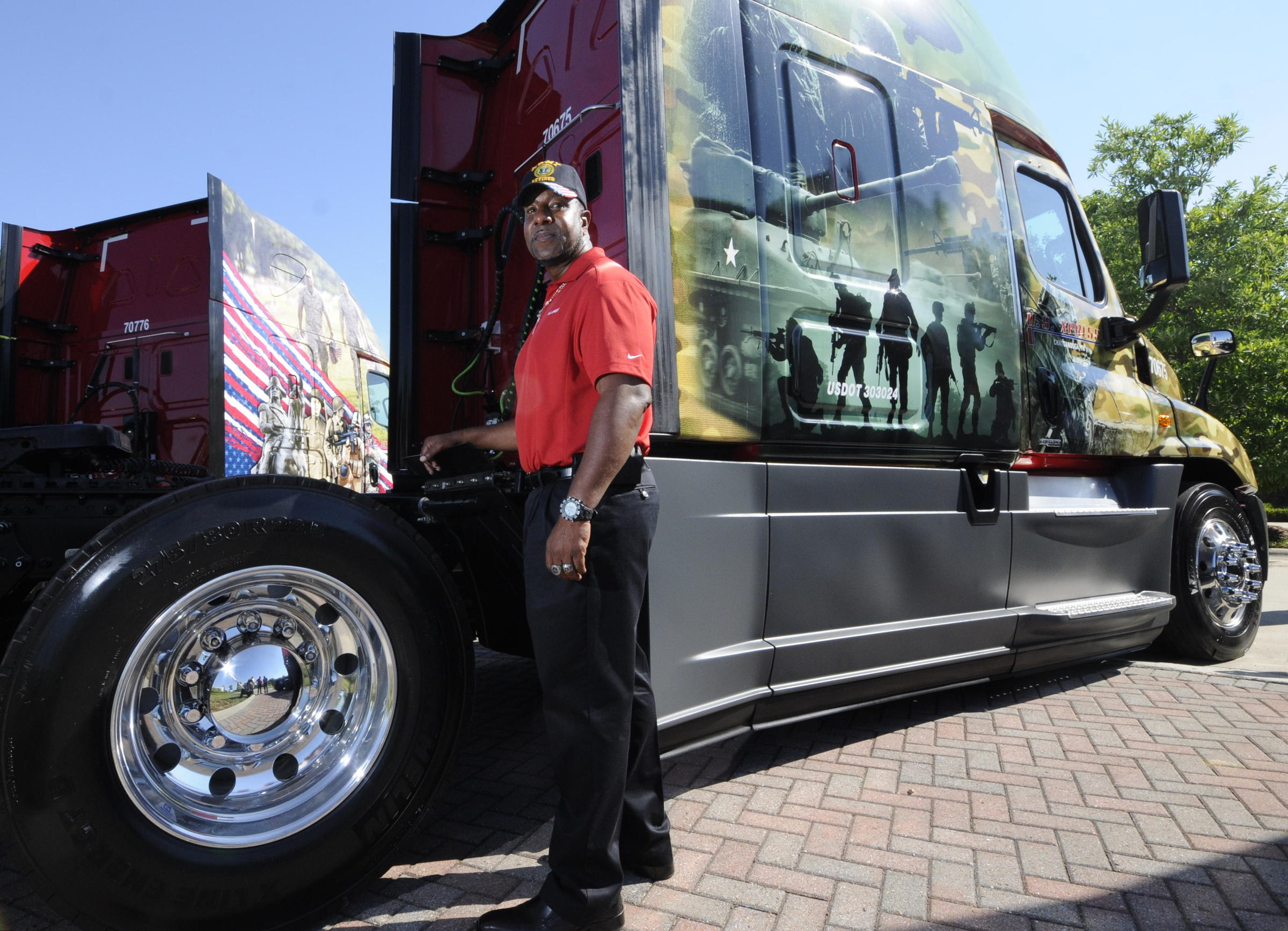 Lincoln Brown, U.S. Army veteran, stands next to his new 
military themed Freightliner truck Friday following a ceremony at the company's Jenkins Road headquarters in Chattanooga.
U.S. Xpress aims to hire more military veterans over coming years.