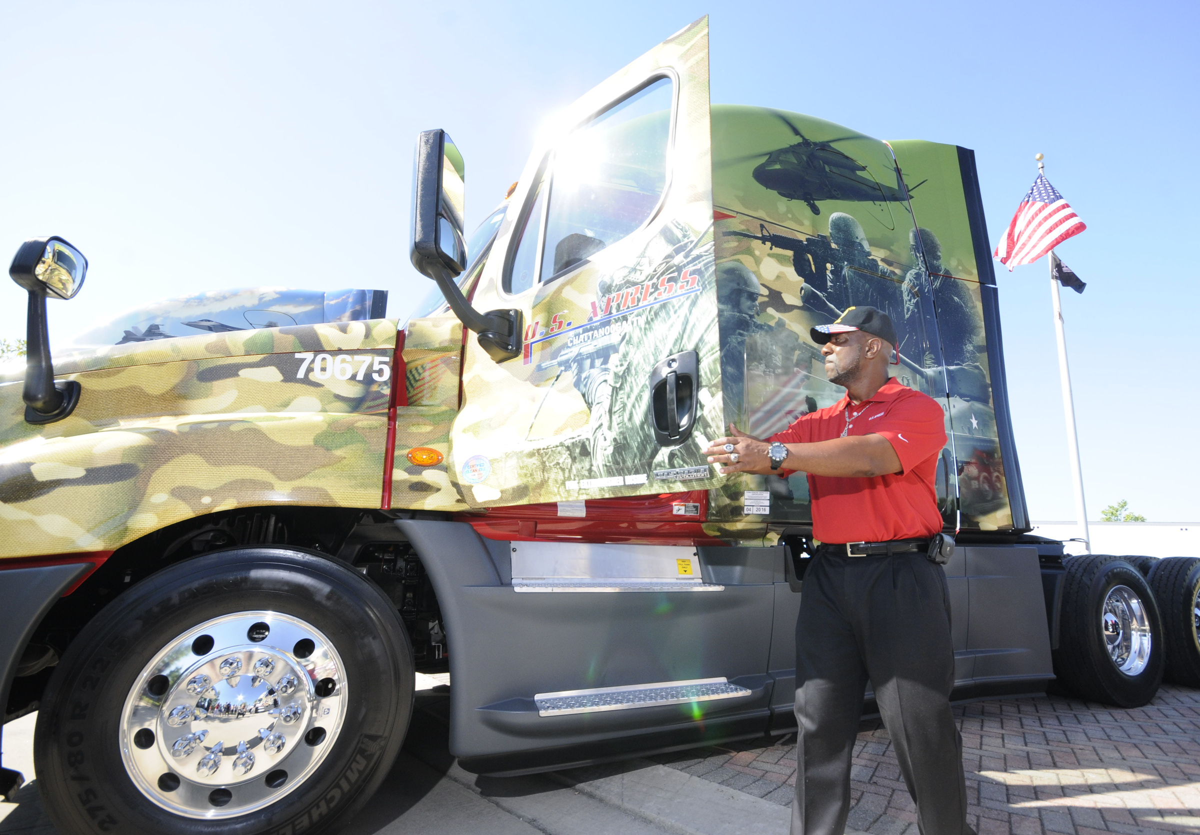 Lincoln Brown, U.S. Army veteran, stands next to his new 
military themed Freightliner truck Friday following a ceremony at the company's Jenkins Road headquarters in Chattanooga. Brown served from 1984 to 2012.
U.S. Xpress aims to hire more military veterans over coming years.