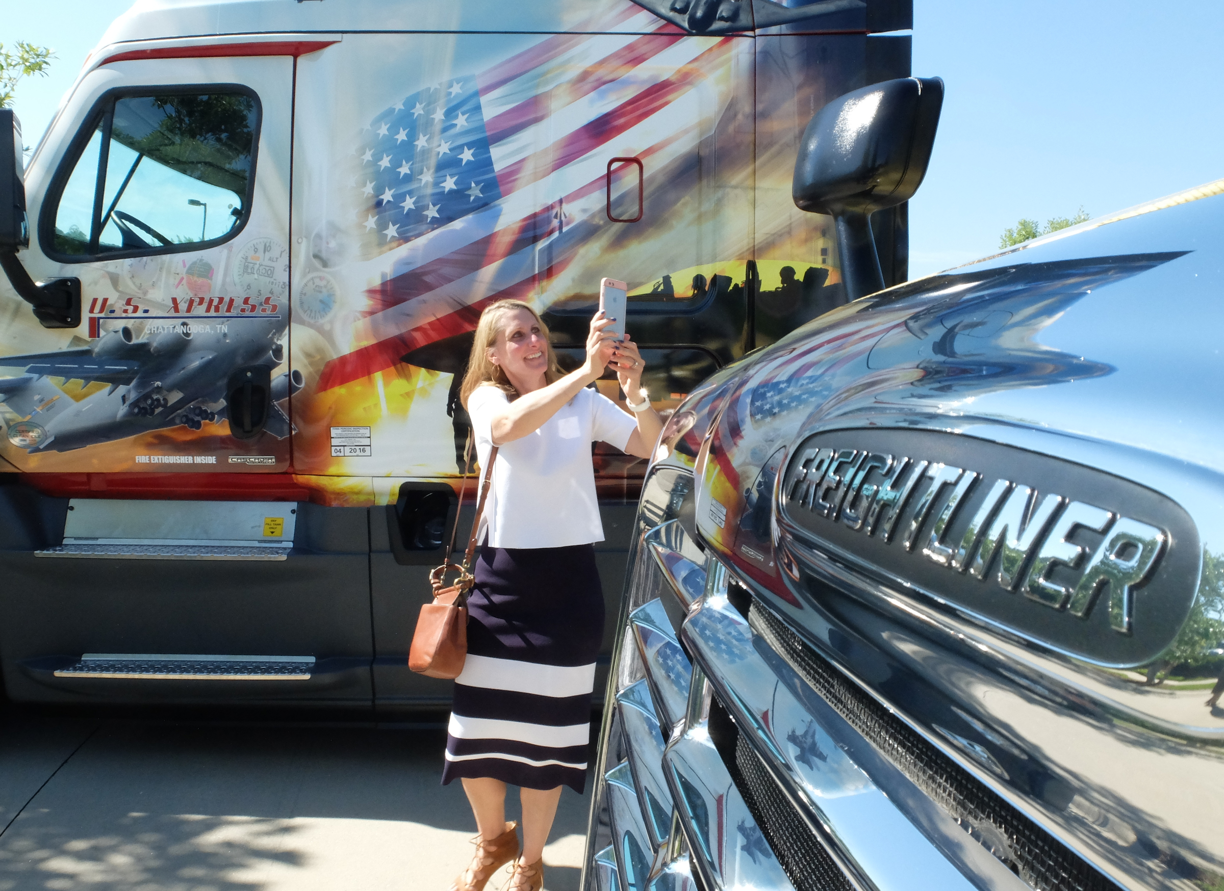 Lisa Pate, chief administrative officer for U.S. Xpress, shoots photos of trucks Friday after the rollout of six new military themed Freightliner units at the company's Jenkins Road headquarters in Chattanooga.
U.S. Xpress aims to hire more military veterans over coming years.