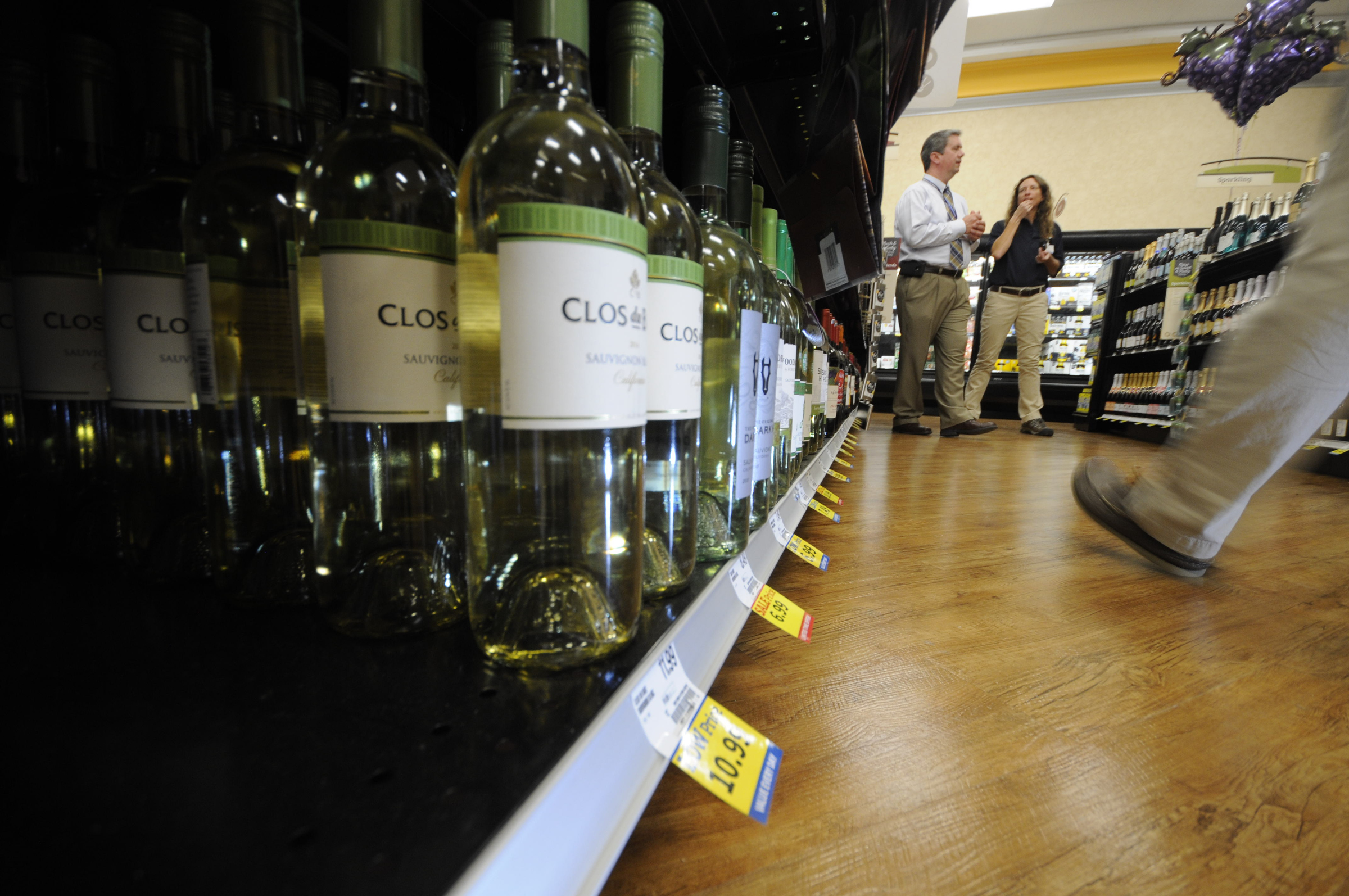 Food City store manager Cary Anselment, left, talks with Mara McVicker in one of the isles stocked with wine at the St. Elmo location on Friday. Chattanooga area grocery stores began selling wine for the first time in Tennessee history. Fully stocked, there are 1,100 bottles of wine available, according to Anselment.