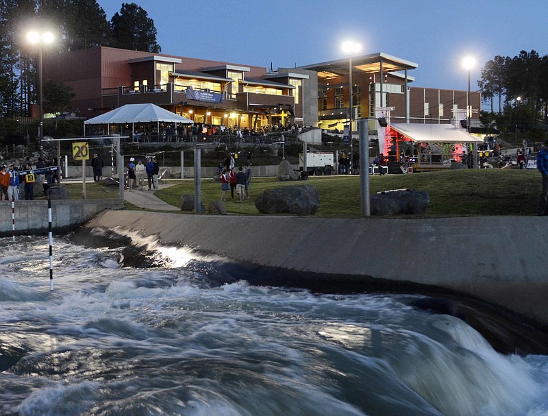 
              FILE - In this April 12, 2012 file photo, water rushes along the course at the National Whitewater Center at dusk on the first day of competition in the canoe slalom Olympic trials, in Charlotte, N.C.  The chlorination and filtration systems at the artificial water rapids course where Olympic kayakers train were inadequate to kill a rare, brain-attacking organism, the U.S. Centers for Disease Control and Prevention said Friday, July 1, 2016, after an Ohio teenager died from the amoeba.   (Robert Lahser/The Charlotte Observer via AP, File)
            