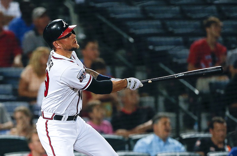 Atlanta Braves pinch hitter Brandon Snyder follows through on a two-run triple in the sixth inning of a baseball game against the Miami Marlins, Thursday, June 30, 2016, in Atlanta. (AP Photo/John Bazemore)