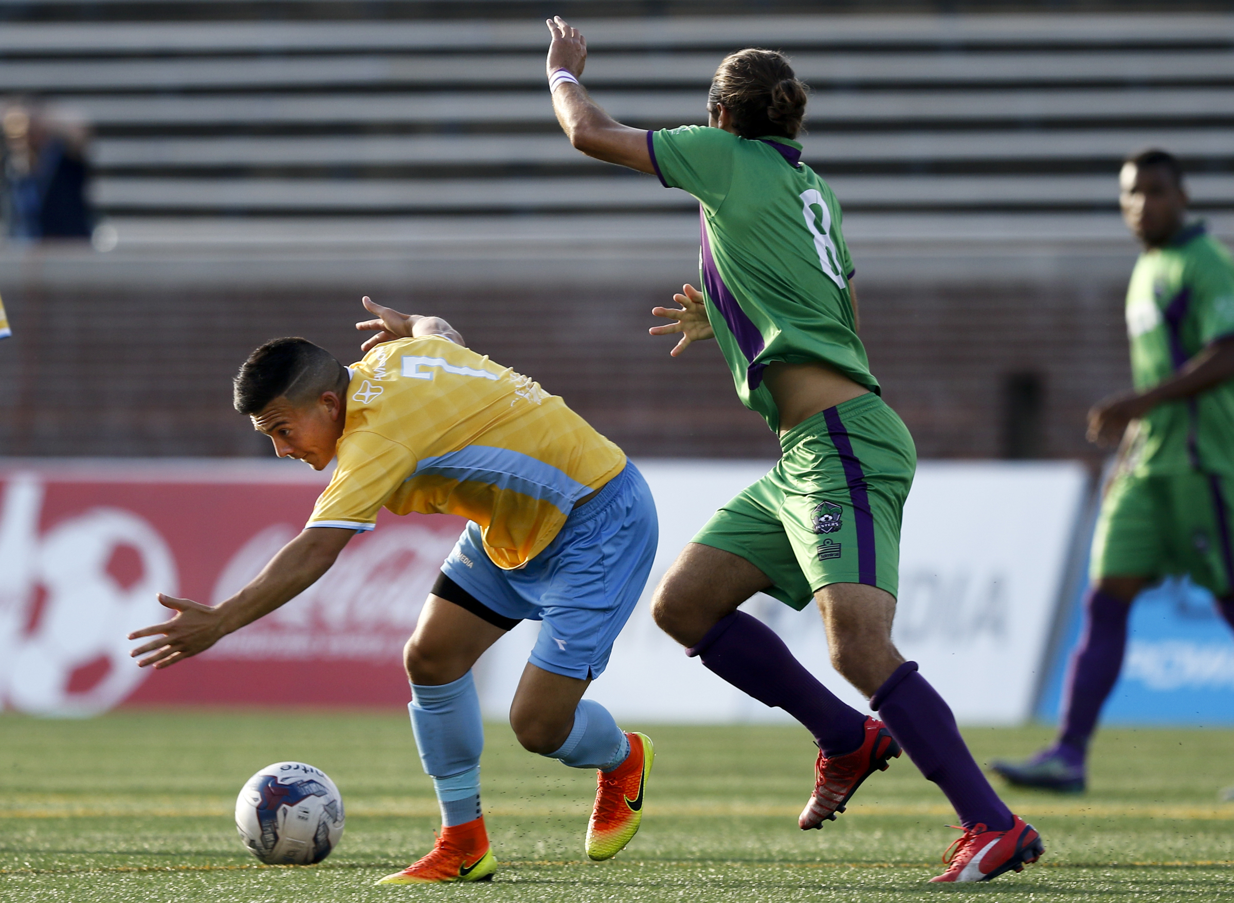 CFC's John Carrier stumbles ahead of New Orleans player Mason Morise during CFC's soccer match against the New Orleans Jesters at Finley Stadium on Saturday, July 2, 2016, in Chattanooga, Tenn.