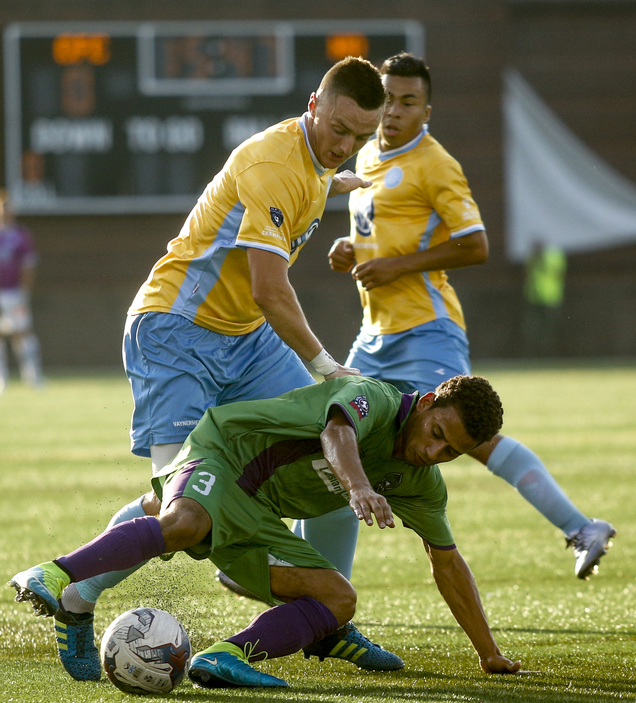New Orleans player Rolando Sanchez stumbles ahead of CFC's Jon Finlay, left, during CFC's soccer match against the New Orleans Jesters at Finley Stadium on Saturday, July 2, 2016, in Chattanooga, Tenn.