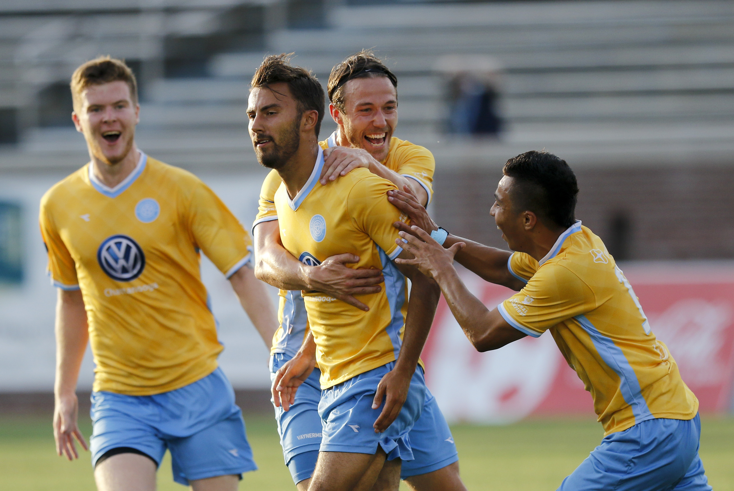 Players celebrate a goal by CFC's Kieran Bywater, center, during CFC's soccer match against the New Orleans Jesters at Finley Stadium on Saturday, July 2, 2016, in Chattanooga, Tenn.