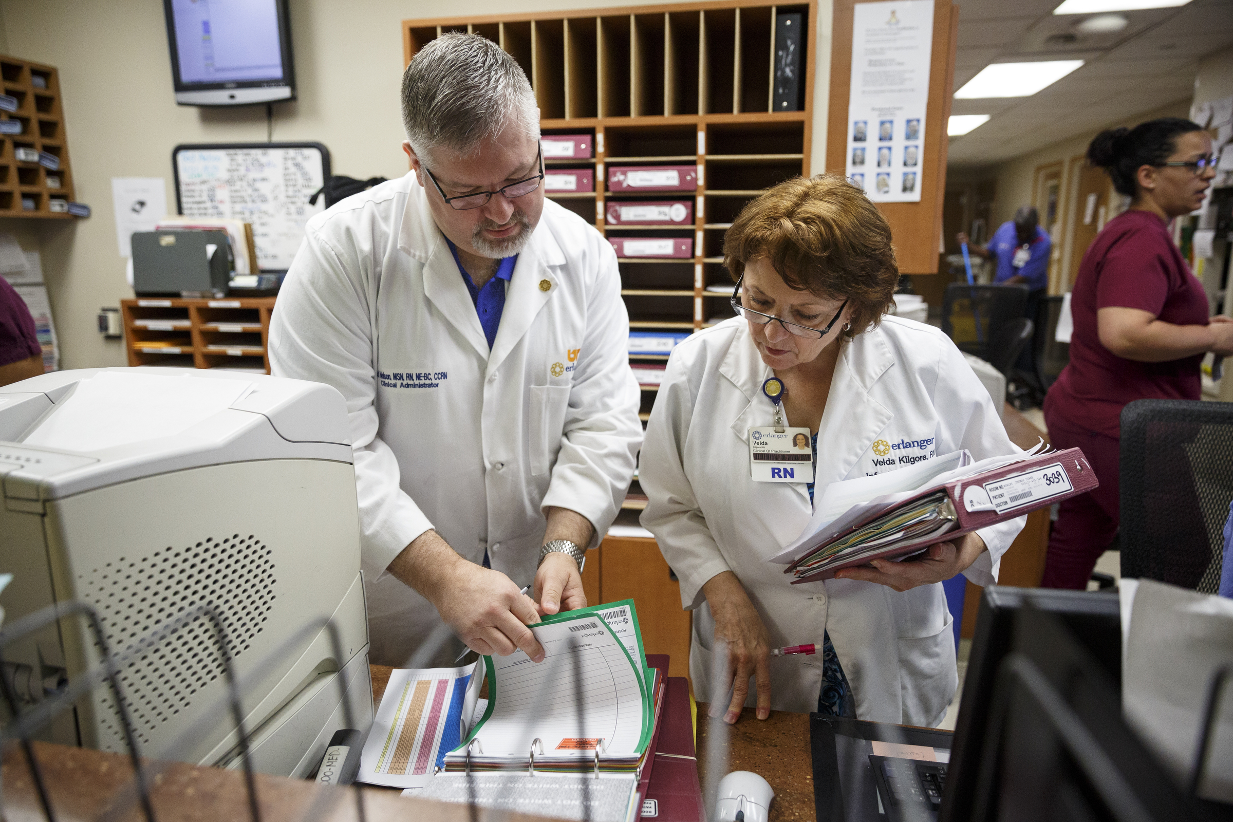 Clinical administrator Ted Nelson, left, and infection prevention nurse Velda Kilgore review charts to check for patients who have received catheters at Erlanger Hospital on Friday, June 24, 2016, in Chattanooga, Tenn. The two are part of a team responsible for ensuring that catheters are properly placed to reduce the chance of infection.