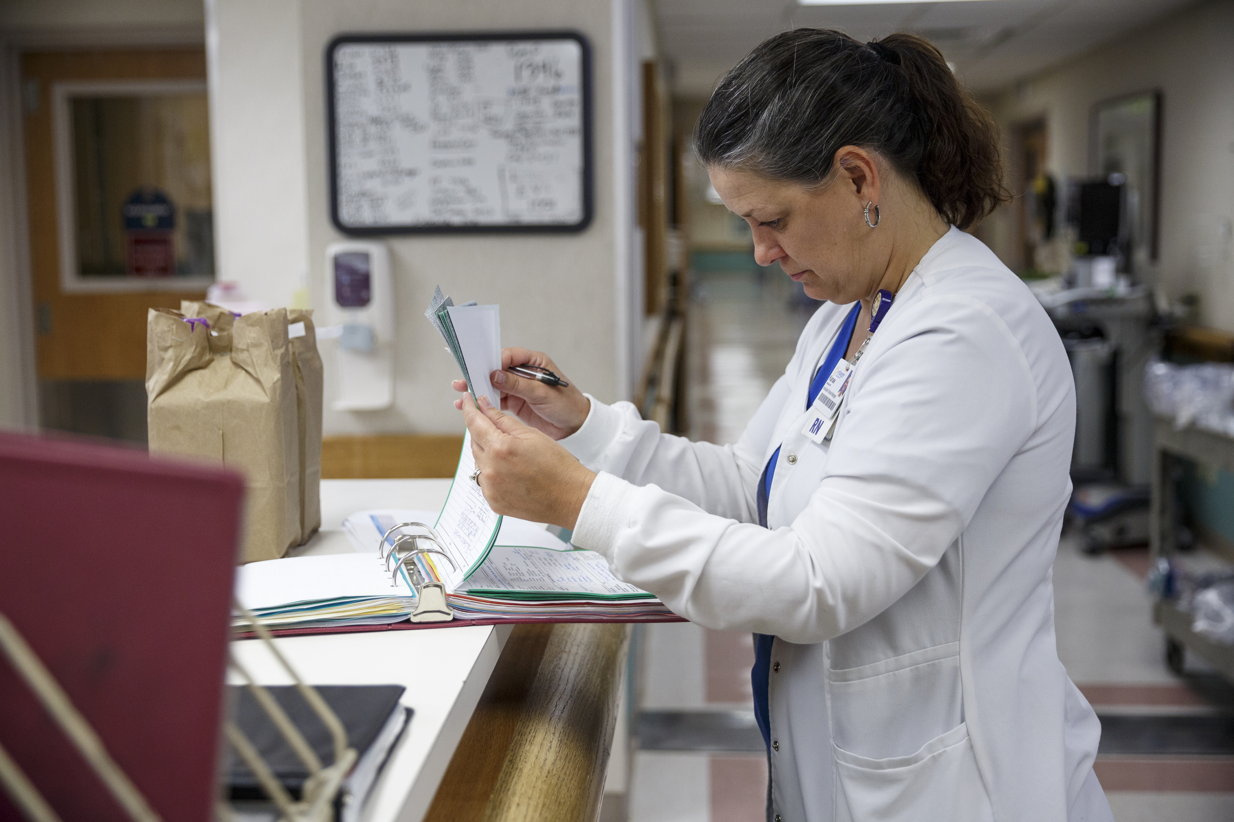 Infection prevention nurse Kanae Gilliland reviews a chart to check whether a patient has received a catheter at Erlanger Hospital on Friday, June 24, 2016, in Chattanooga, Tenn. Gilliland is part of a team responsible for ensuring that catheters are properly placed to reduce the chance of infection.