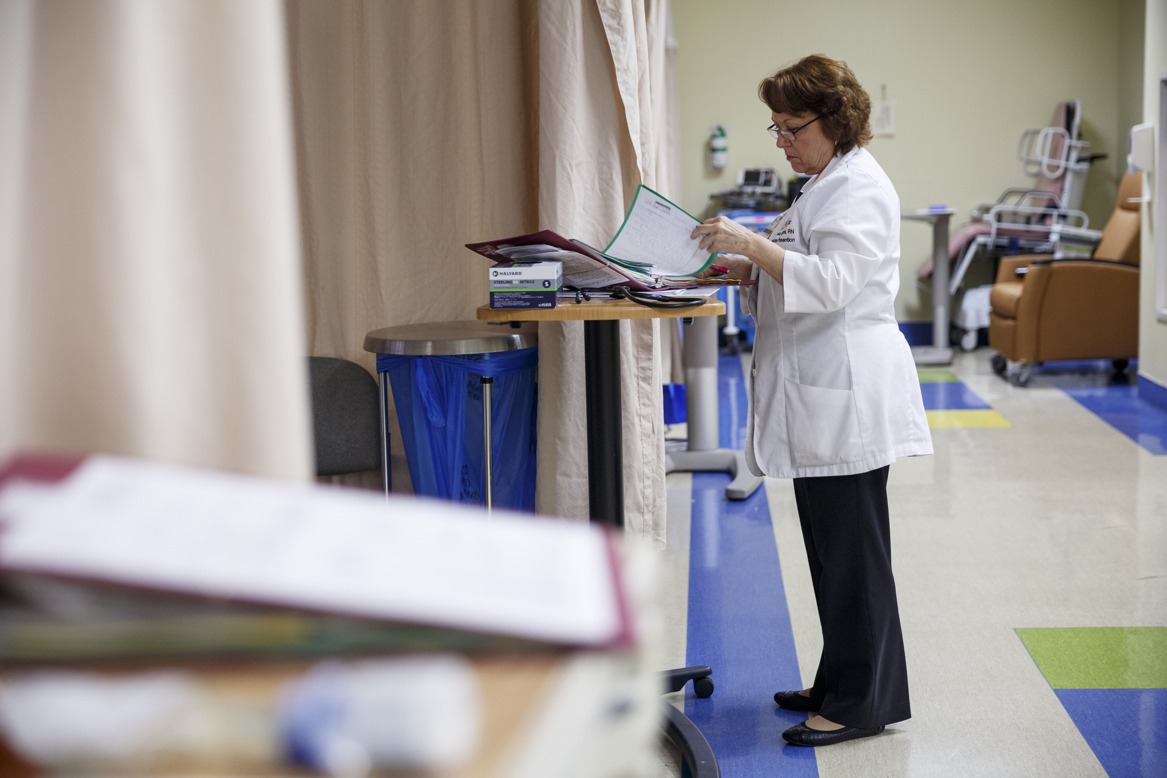 Infection prevention nurse Velda Kilgore reviews a patient's chart to check for a catheter entry at Erlanger Hospital on Friday, June 24, 2016, in Chattanooga, Tenn. Kilgore is part of a team responsible for ensuring that catheters are properly placed to reduce the chance of infection.