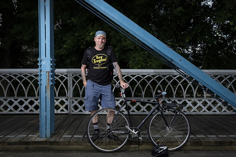 Mark Gardner, founder of the bicycle courier business Hey Eugene Delivers!, poses for a portrait on the Market Street Bridge on Tuesday, June 28, 2016, in Chattanooga, Tenn. Gardner recently moved to Chattanooga from New York City.