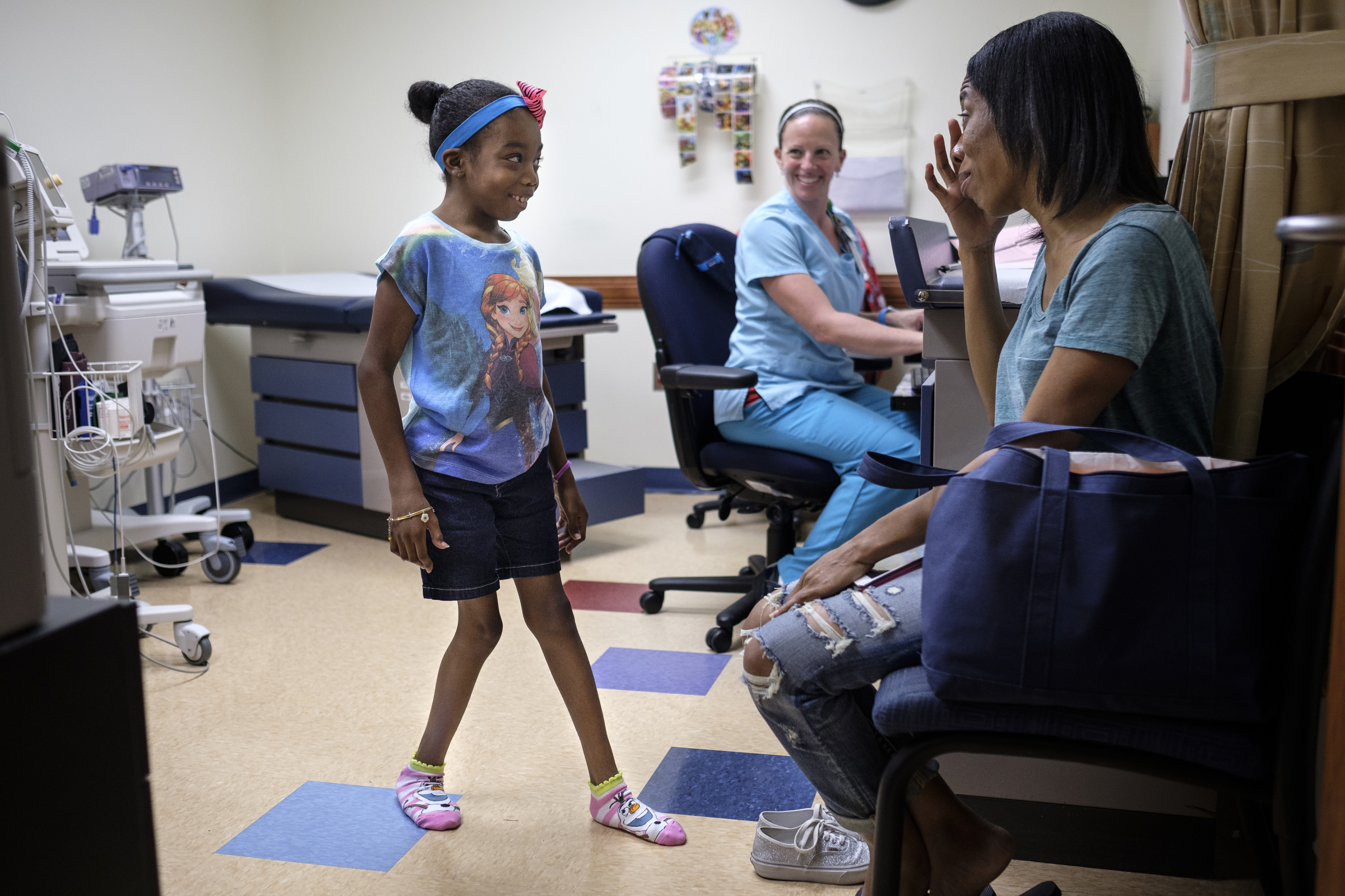Ahmya Calloway, left, jokes with her mom Darnima, right, and nurse Terri Bartek as she goes through one of her regular checkups to monitor her new heart at Vanderbilt Children's Hospital on Thursday, June 30, 2016, in Nashville, Tenn. Almost two months after receiving a heart and kidney transplant, Ahmya was told she could transition to once-weekly checkups and return home to Chattanooga.