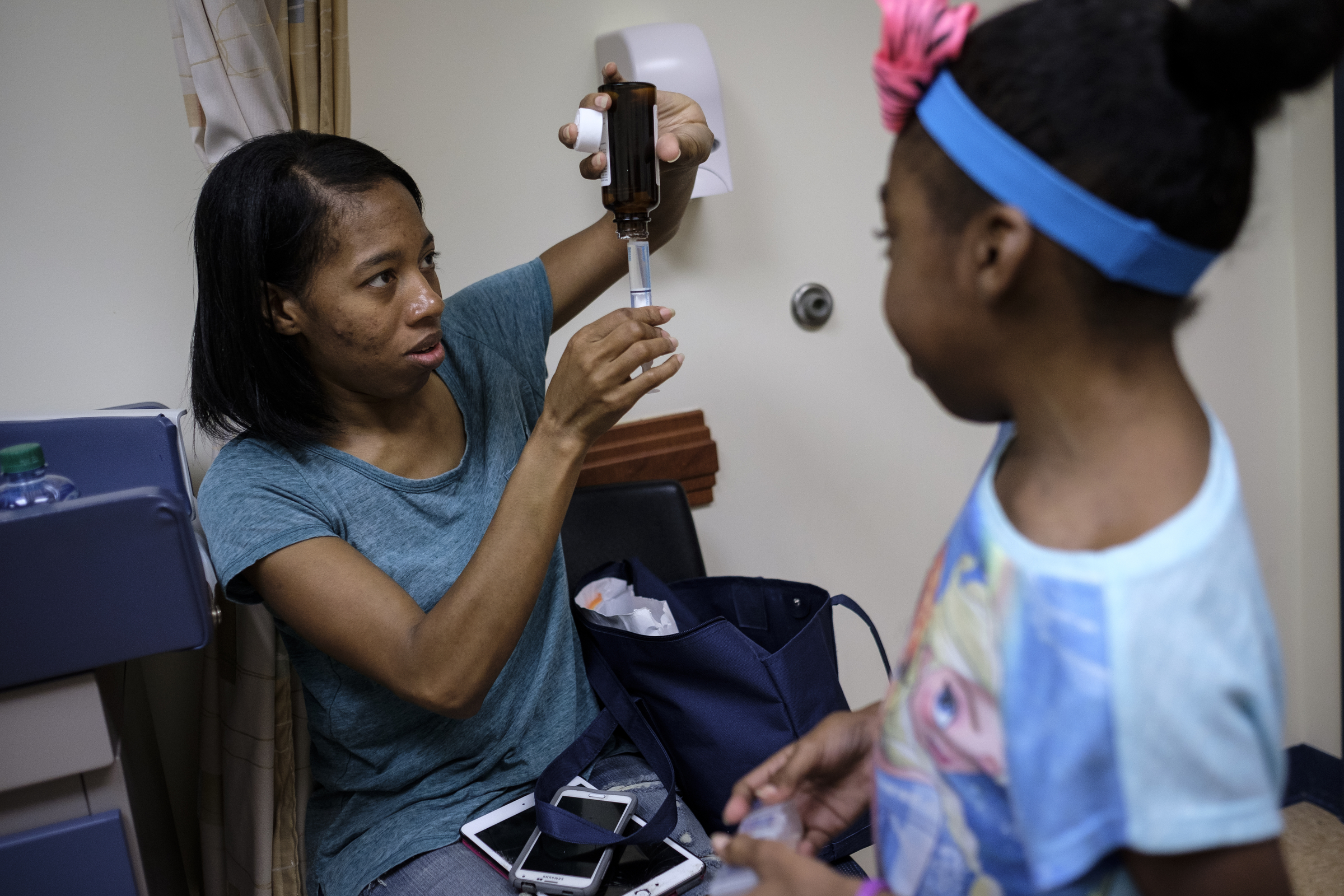 Darnima Calloway measures out a dose of medication for her daughter Ahmya at Vanderbilt Children's Hospital on Thursday, June 30, 2016, in Nashville, Tenn. Ahmya will spend the rest of her life on anti-rejection drugs so that her body does not reject her transplanted heart and kidney.