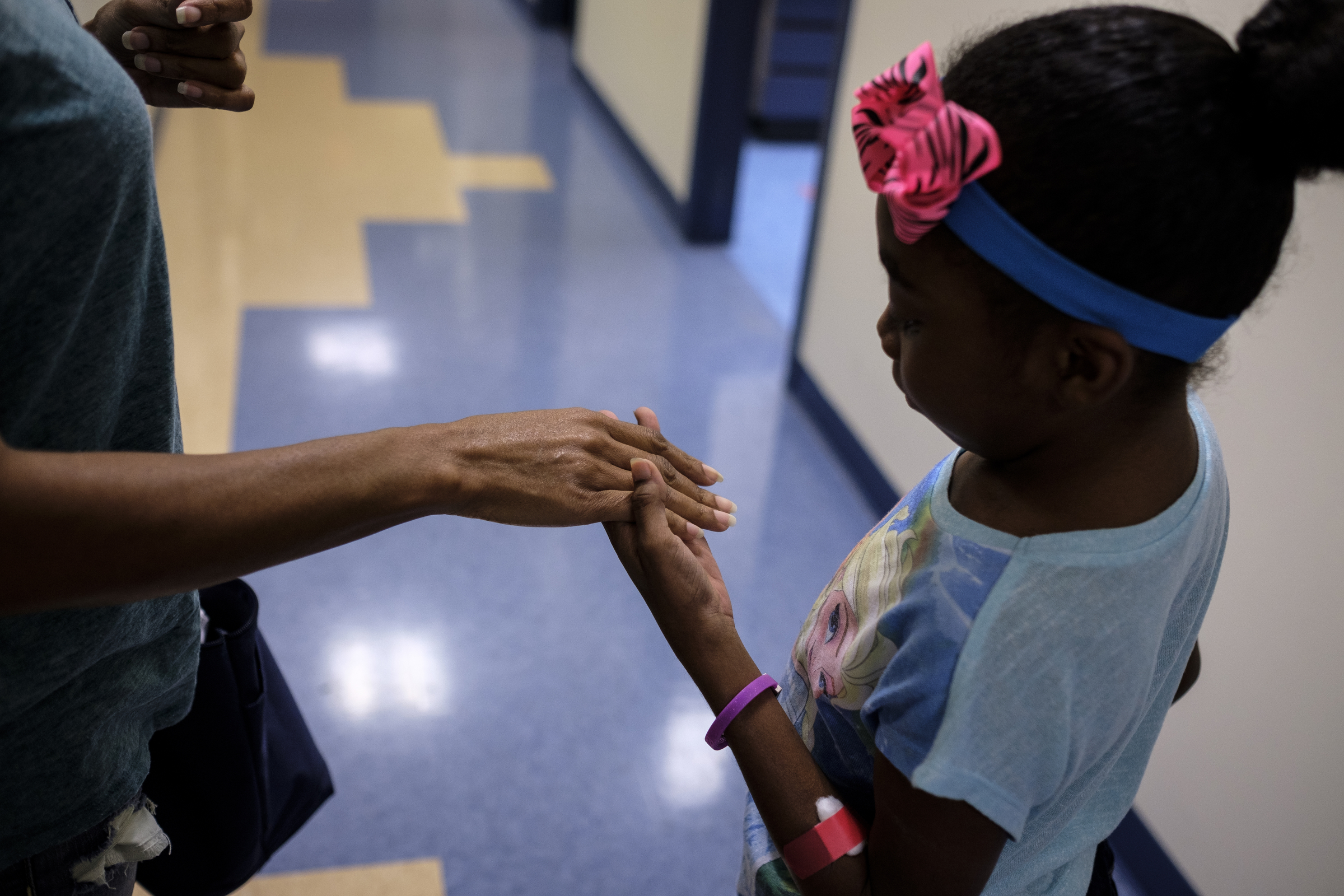 Ahmya Calloway holds her mother Darnima's hand as they walk between appointments Vanderbilt Children's Hospital on Thursday, June 30, 2016, in Nashville, Tenn. Almost two months after receiving a heart and kidney transplant, Ahmya was told she could transition to once-weekly checkups and return home to Chattanooga.