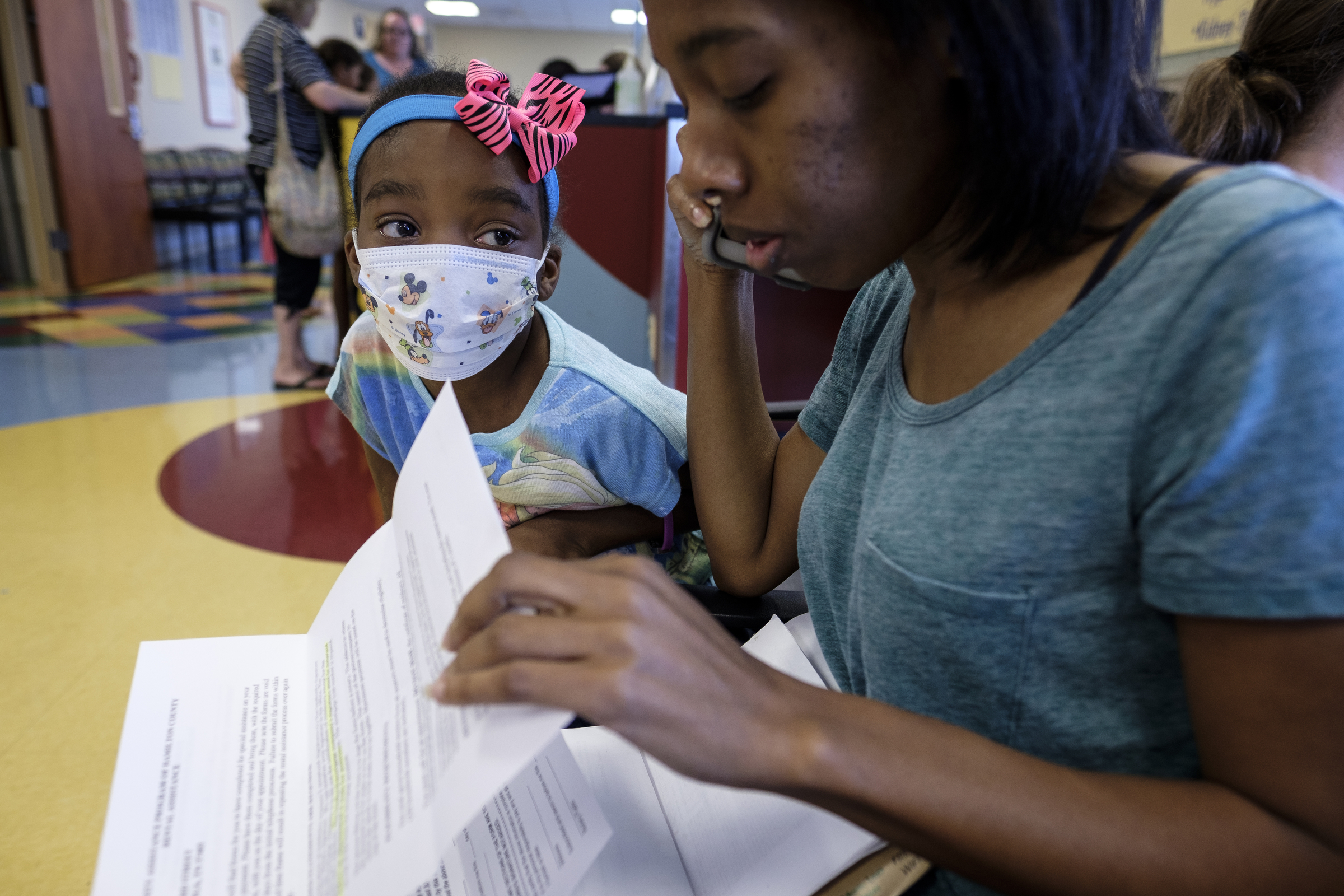 Ahmya Calloway wears a surgical mask to protect from contagious illnesses as she watches her mother Darnima make phone calls to manage life back in Chattanooga from a waiting room at Vanderbilt Children's Hospital on Thursday, June 30, 2016, in Nashville, Tenn. Darnima has been staying in Nashville since Ahmya's transplant. The anti-rejection drugs Ahmya must take for the rest of her life to ensure her body does not reject her transplanted heart or kidney also weaken her immune system.