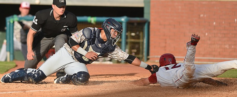 Chattanooga Lookouts's Zach Granite is out as the plate as Birmingham Barons catcher Alfredo Gonzalez makes the tag for an out Monday, July 4, 2016 at AT&T Field.