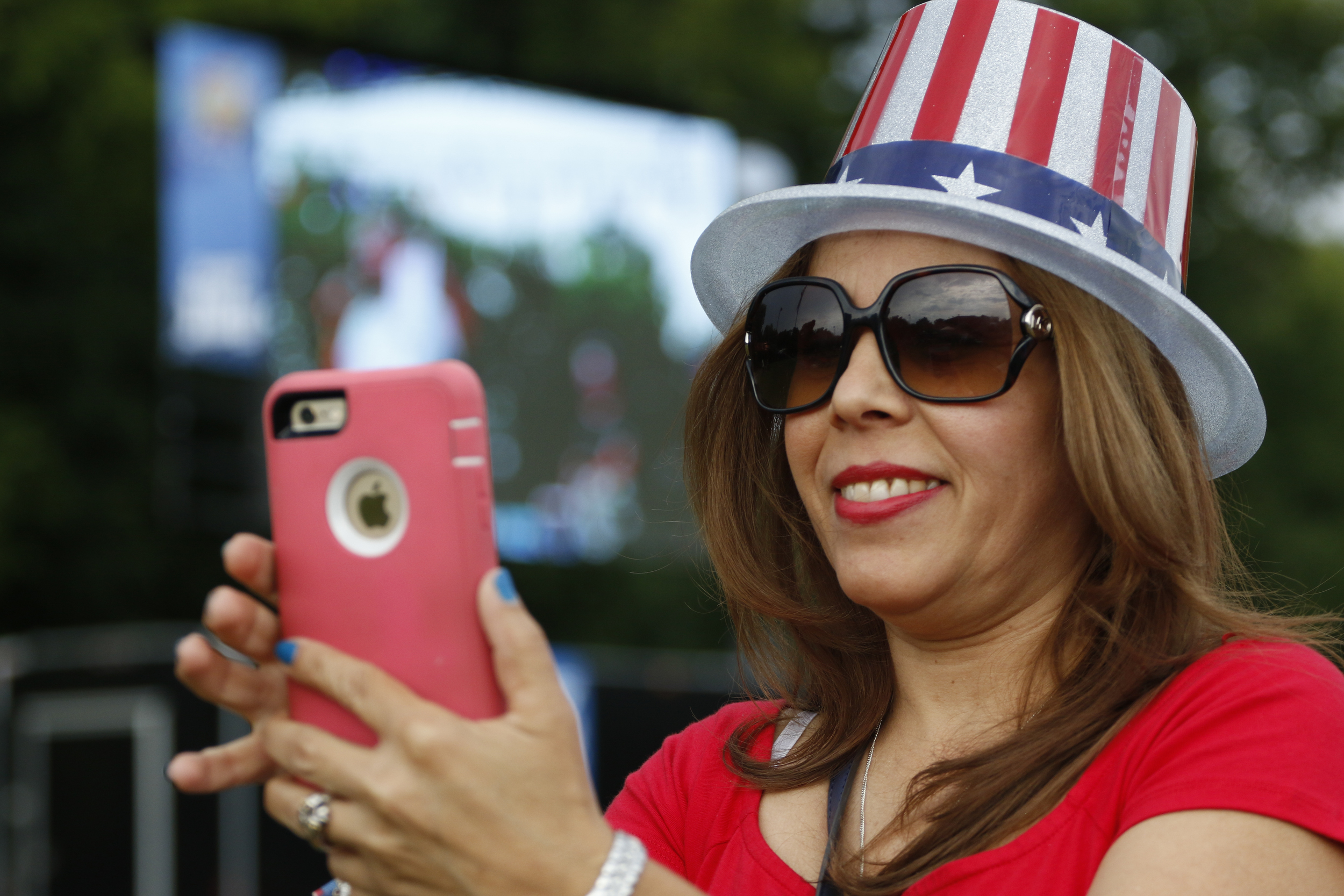 Sheida Rosario takes photos during the Independence Day festivities being held at Veterans Memorial Park in Collegedale, TN., on Sunday, July 3, 2016.