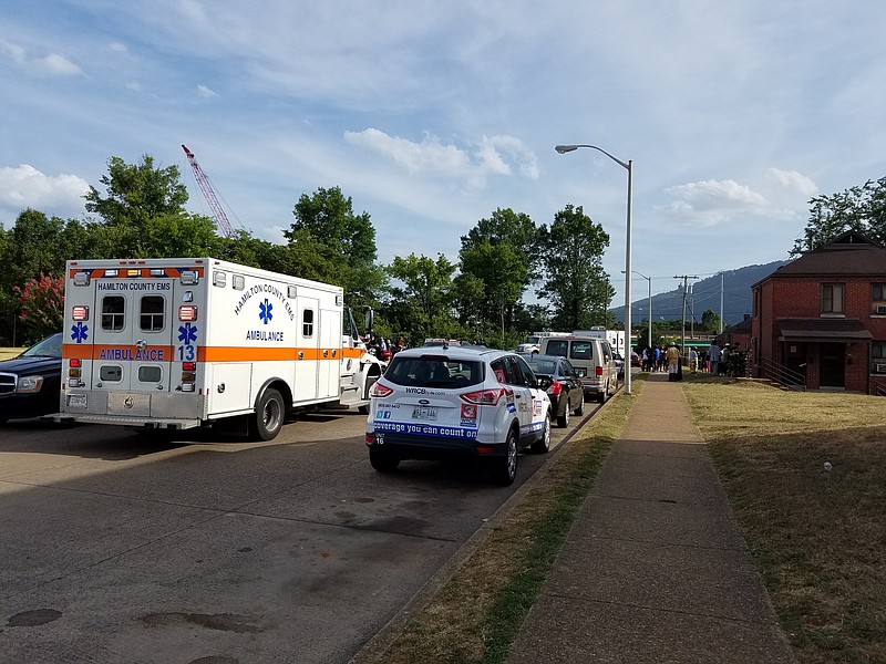 Neighbors stand near emergency vehicles at Main Street Court on July 4. Chattanooga police are investigating the death of Aisha Hood, 23, whose family found her in her apartment on her birthday.