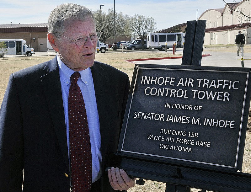 
              FILE - In this March 4, 2016 file photo, U.S. Senator James Inhofe stands next to a plaque bearing his name after a dedication ceremony for the new air traffic control town at Vance Air Force Base in Enid, Oklahoma. Severe weather forced Inhofe to land an airplane at a small airport in Oklahoma, his spokeswoman said Sunday night, July 3, 2016. Donelle Harder, a spokeswoman for the Oklahoma Republican, said Inhofe was out flying Sunday evening when the weather forced him to land in Ketchum, about 70 miles northeast of Tulsa. (Billy Hefton/The Enid News & Eagle via AP, File)
            