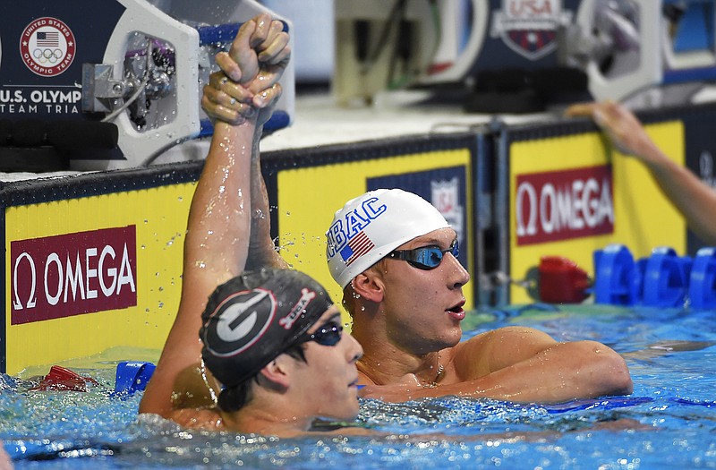 
              FILE - This June 26, 2016 file photo shows Chase Kalisz celebrating with Jay Litherland, left, after winning the men's 400-meter individual medley final at the U.S. Olympic swimming trials in Omaha, Neb. Litherland finished in second place. The Litherlands left everyone seeing triple at the U.S. Olympic swimming trials. Jay, Kevin and Mick are 20-year-old triplets who competed in Omaha over the past week. While Jay was the only one to earn a spot in Rio, they'll all be there in spirit. (AP Photo/Mark J. Terrill, File)
            