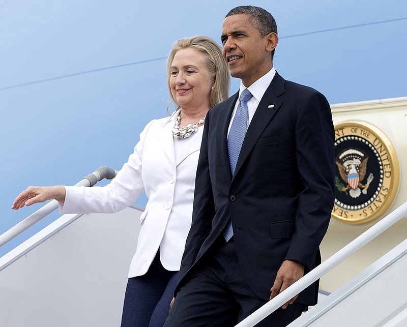 In this Nov. 19, 2012, file photo, President Barack Obama and then-Secretary of State Hillary Clinton arrive at Yangon International Airport in Yangon, Myanmar, on Air Force One.