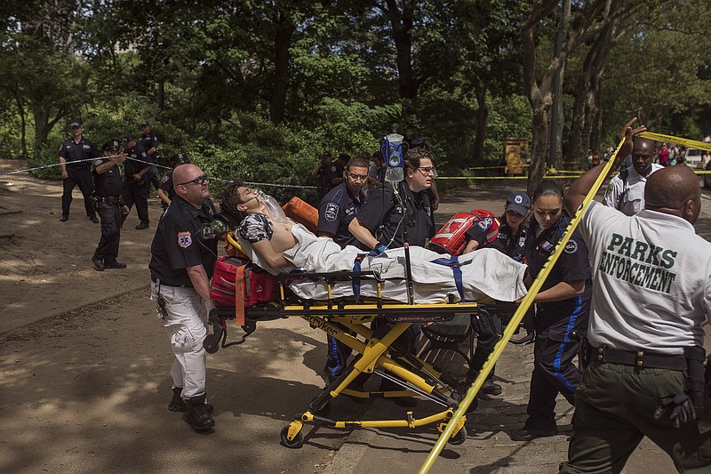 A injured man is carried to an ambulance in Central Park in New York, Sunday, July 3, 2016. Authorities say a man was seriously hurt in Central Park and people near the area reported hearing some kind of explosion. Fire officials say it happened shortly before 11 a.m., inside the park at 68th Street and Fifth Avenue.