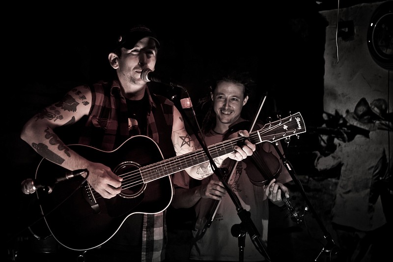 Snake Blood Remedy was founded by lead singer J.D. Cook, left. He's joined by Ken Rawson (fiddle, right). Not pictured in the current lineup are Mitch III Eagle (drums/percussion/ukulele/guitar), Tara Rawson (bass), Micky Lynn (banjo), Brett Bass (resonator guitar) and Jon Murphy (bass). The Florida-based band will provide the music to which Jesco White, "The Dancing Outlaw," will buck dance during a show Saturday, July 9, at Revelry Room.