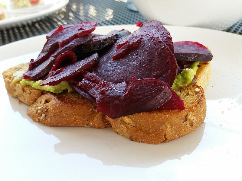 Avo Toast, as served at The Daily Ration, is an open-faced sandwich with smashed avocado, roasted beets and a sprinkling of chili-lime salt.
