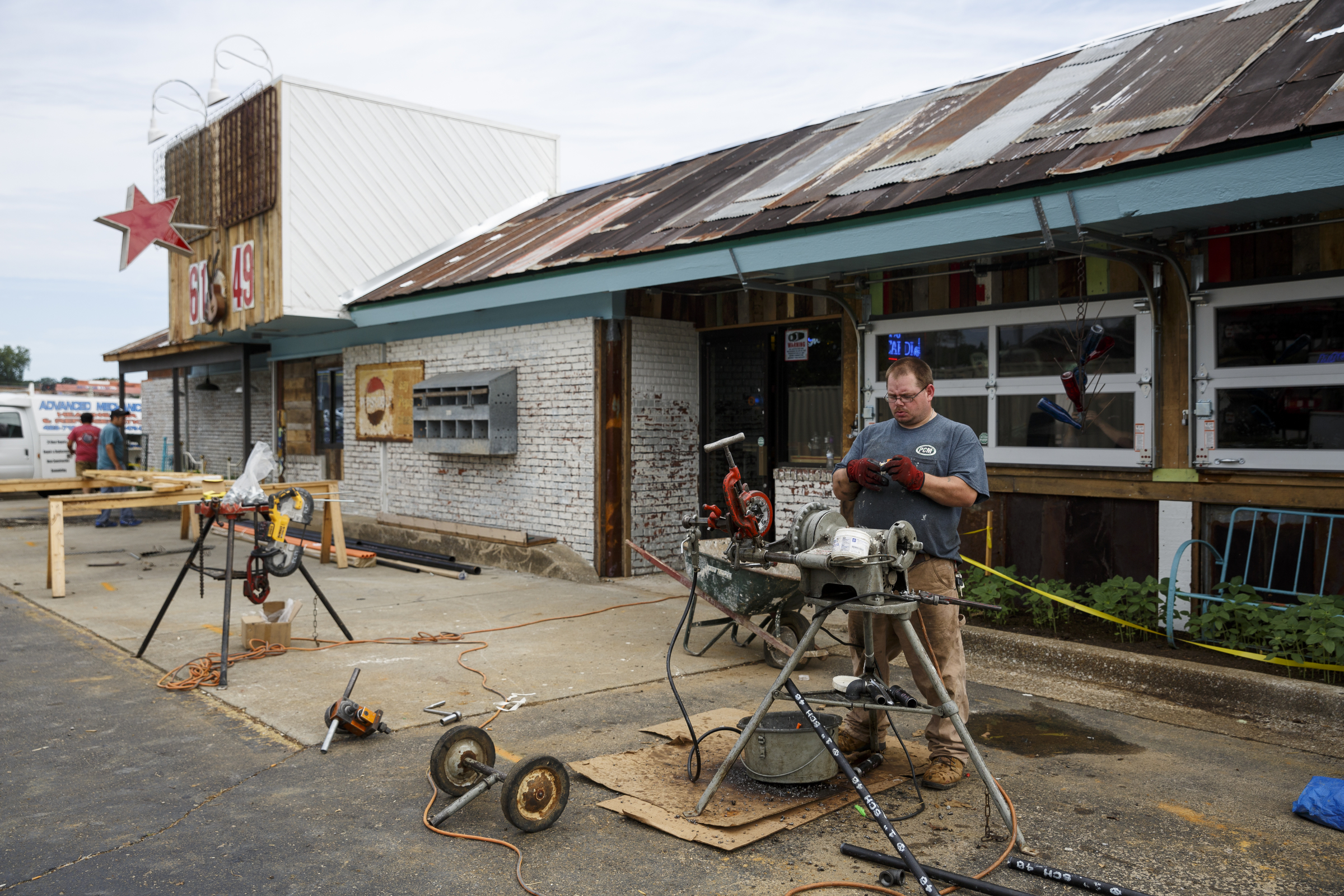 Phillip Hughes machines metal pieces outside the new Lee Highway location of Champy's Fried Chicken which is under construction Tuesday, June 28, 2016, in Chattanooga, Tenn.