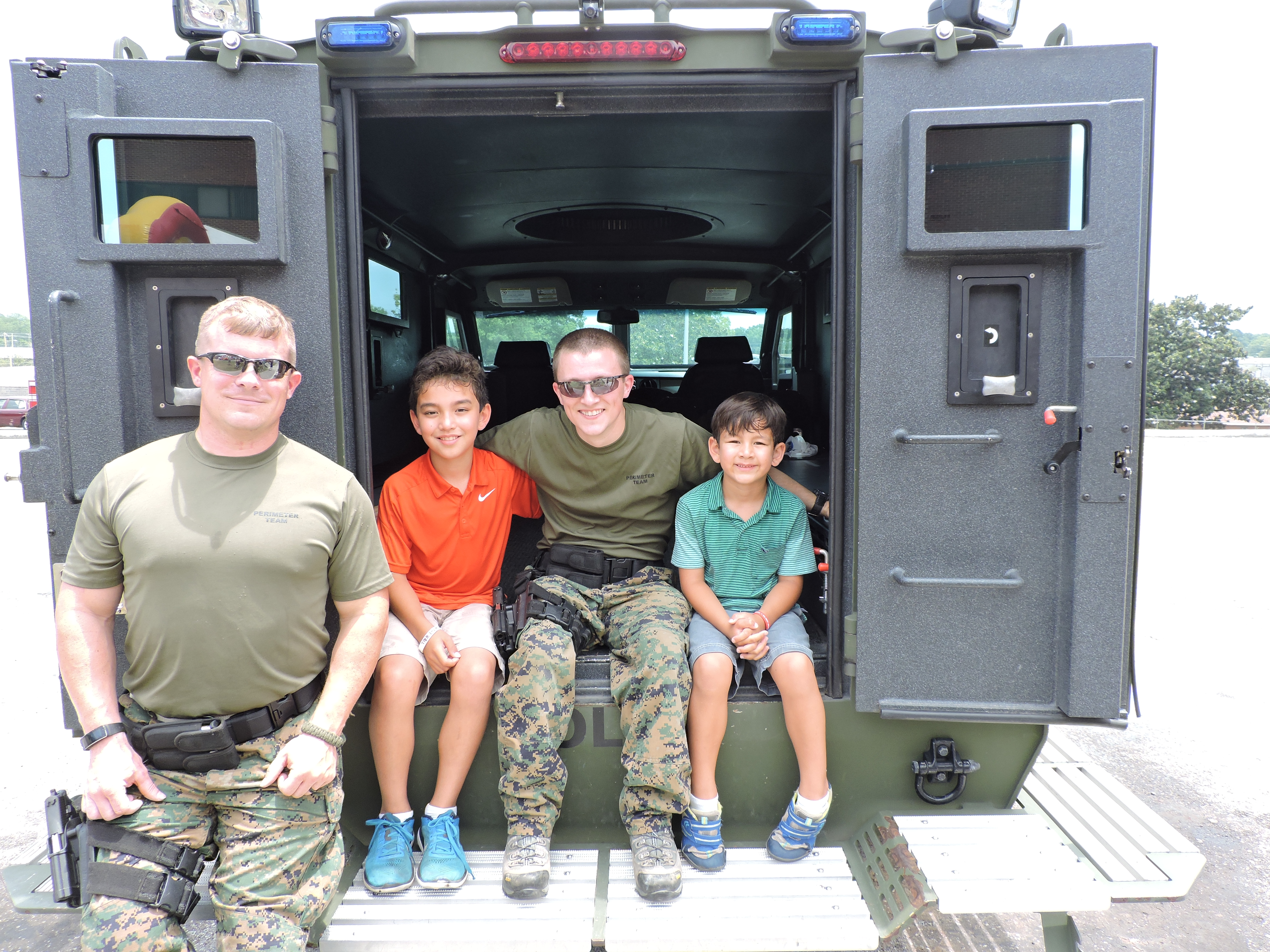 SWAT Team of Chattanooga Officer Derek Roncin, Tyler Robinson, 10, SWAT Team of Chattanooga Officer Jarrod Justice and Ryan Robinson, 6, from left, check out the inside of a SWAT Team special vehicle.