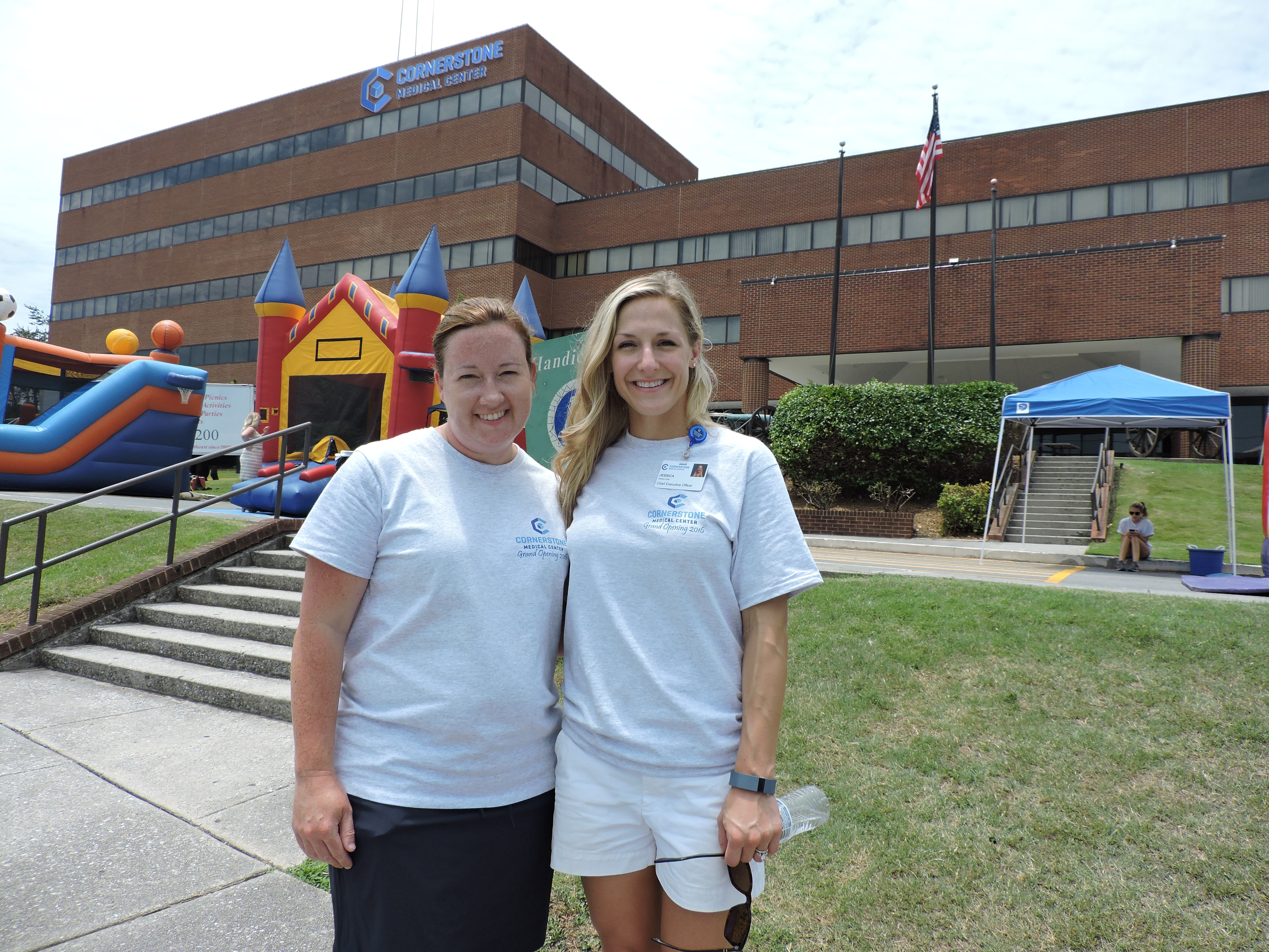 Apollo MD Communications Director Kimberly Johnson, left, and Cornerstone Medical Center Chief Executive Officer Jessica Long welcome families to the Family Fun Day at Cornerstone Medical Center. 